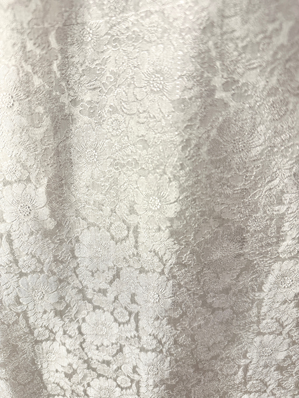 "Traditional Vietnamese Ao Dai Pants in white jacquard silk with chrysanthemum pattern."