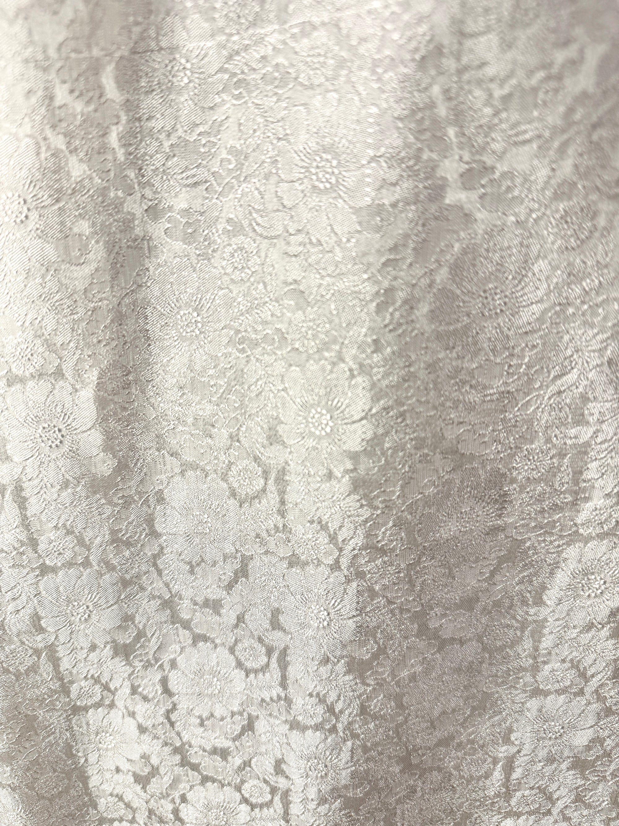 "Traditional Vietnamese Ao Dai Pants in white jacquard silk with chrysanthemum pattern."
