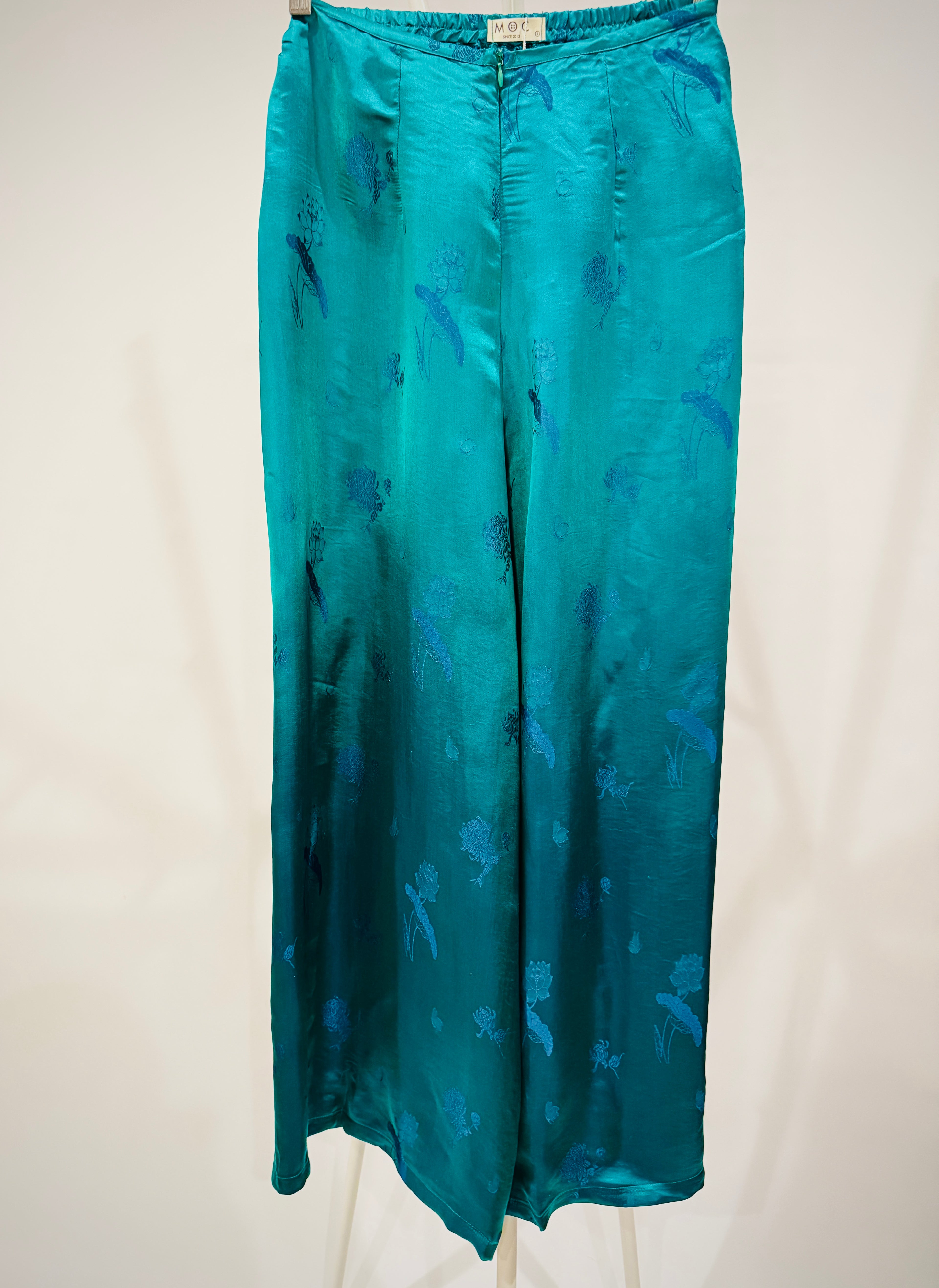 "Lotus pattern Ao Dai pants in green silk jacquard, traditional Vietnamese design by Moc."