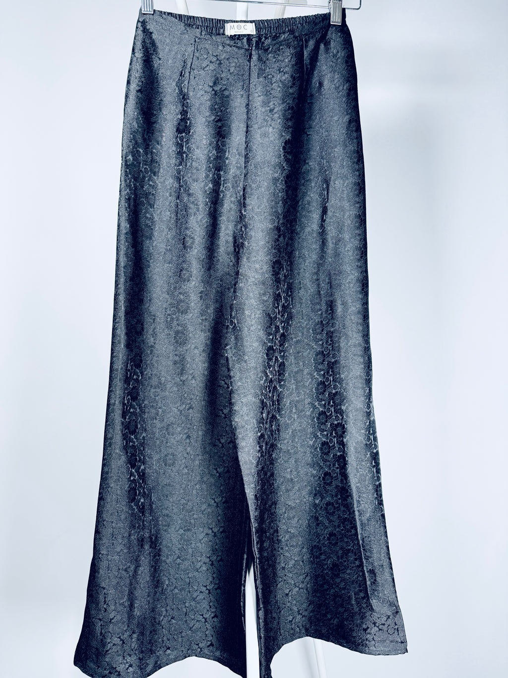 "Traditional Vietnamese Ao Dai pants in black silk with chrysanthemum jacquard pattern by Moc."