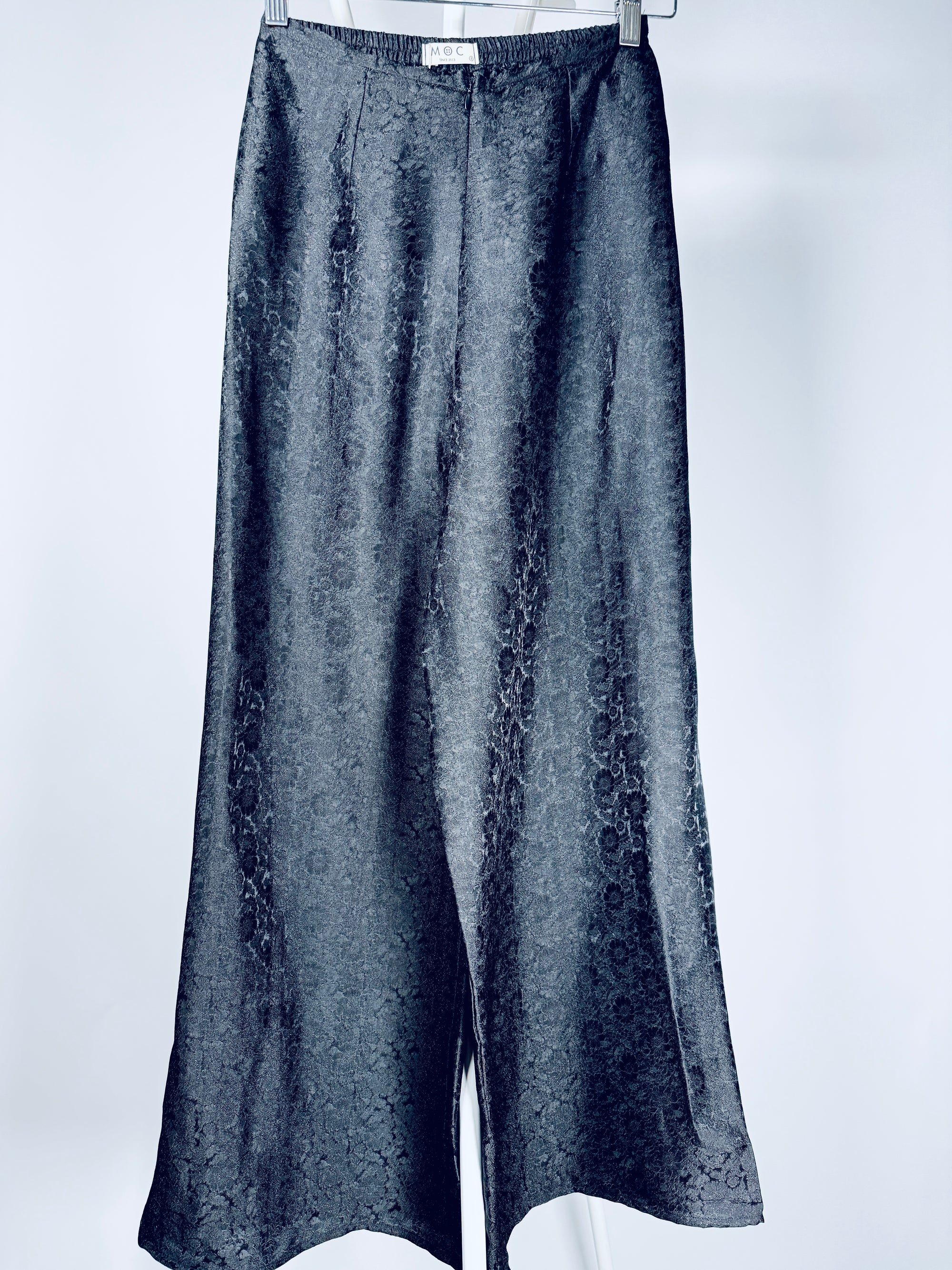 "Traditional Vietnamese Ao Dai pants in black silk with chrysanthemum jacquard pattern by Moc."