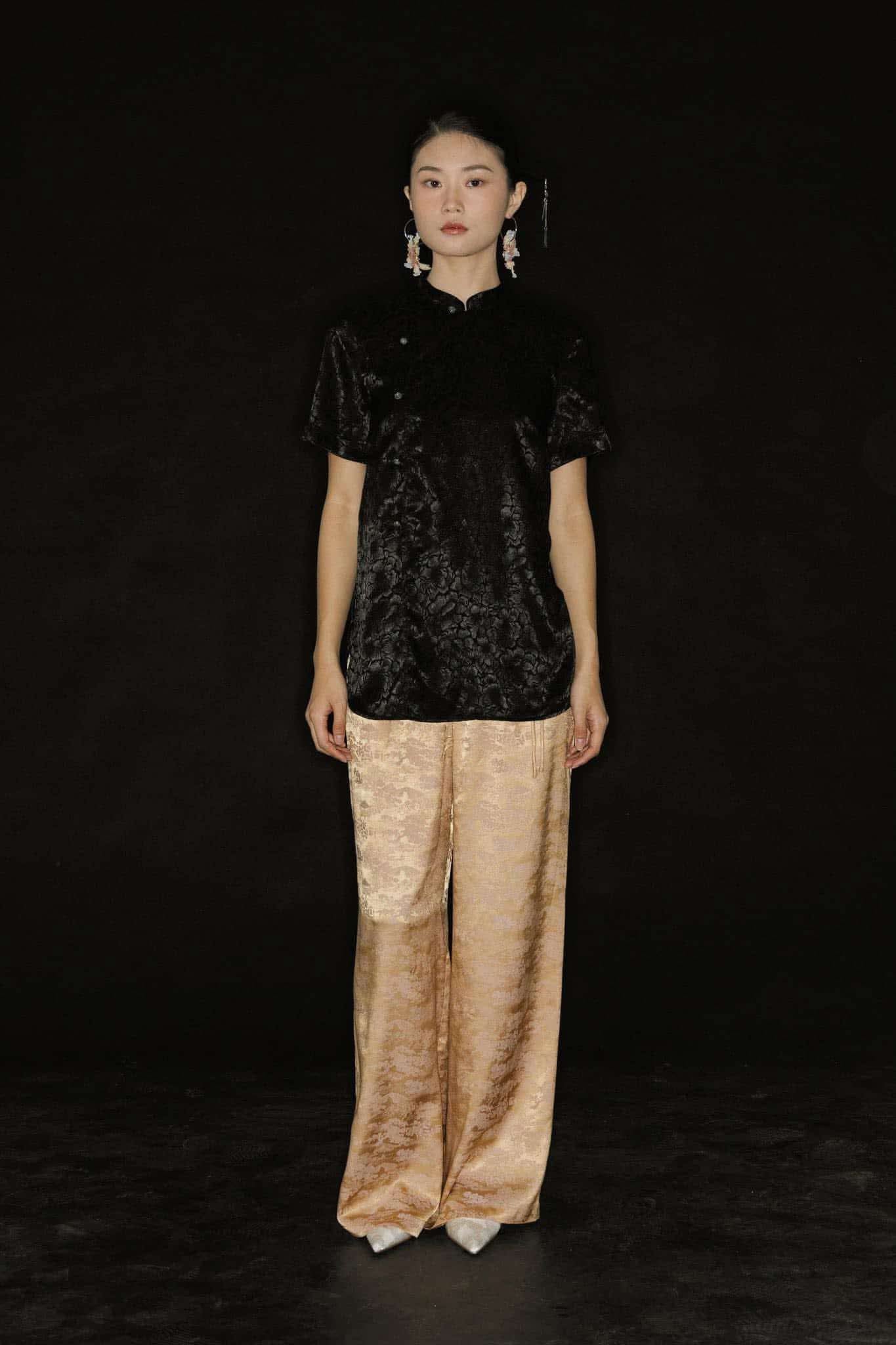 "Vietnamese 'Tinh Duyen' set with black silk Mandarin top and jacquard wide-leg pants by Hy Phuong"