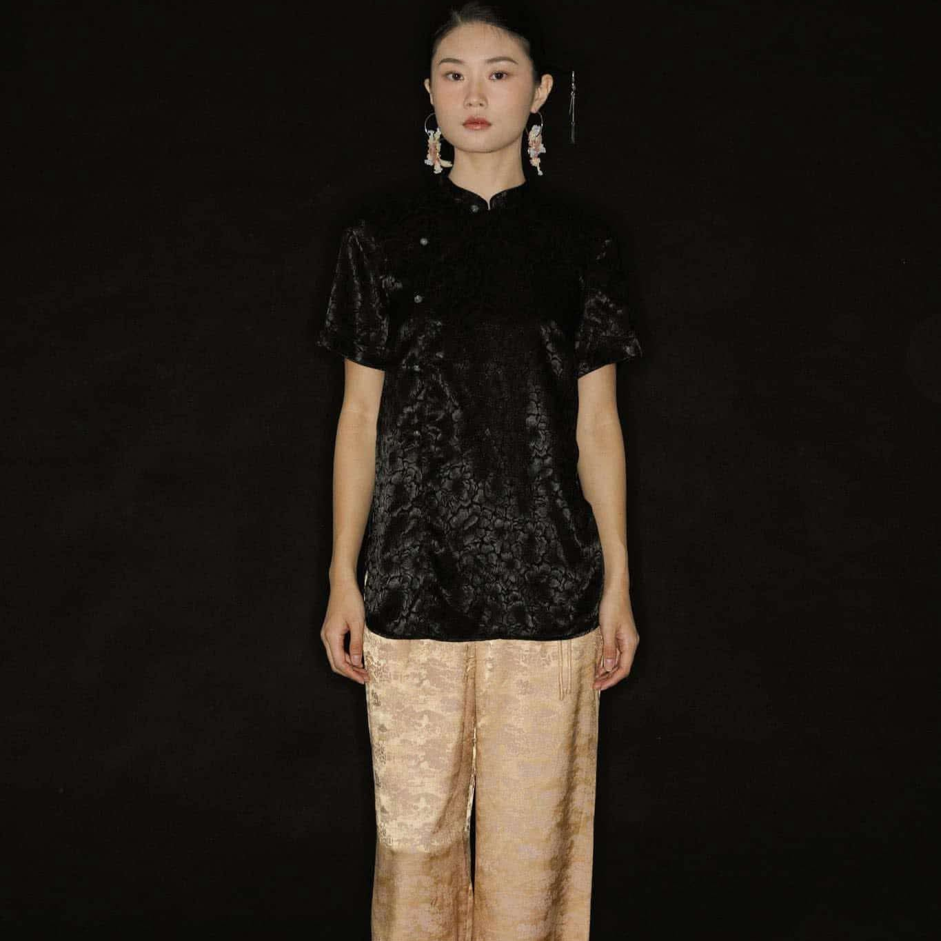 "Vietnamese 'Tinh Duyen' set with black silk Mandarin top and jacquard wide-leg pants by Hy Phuong"