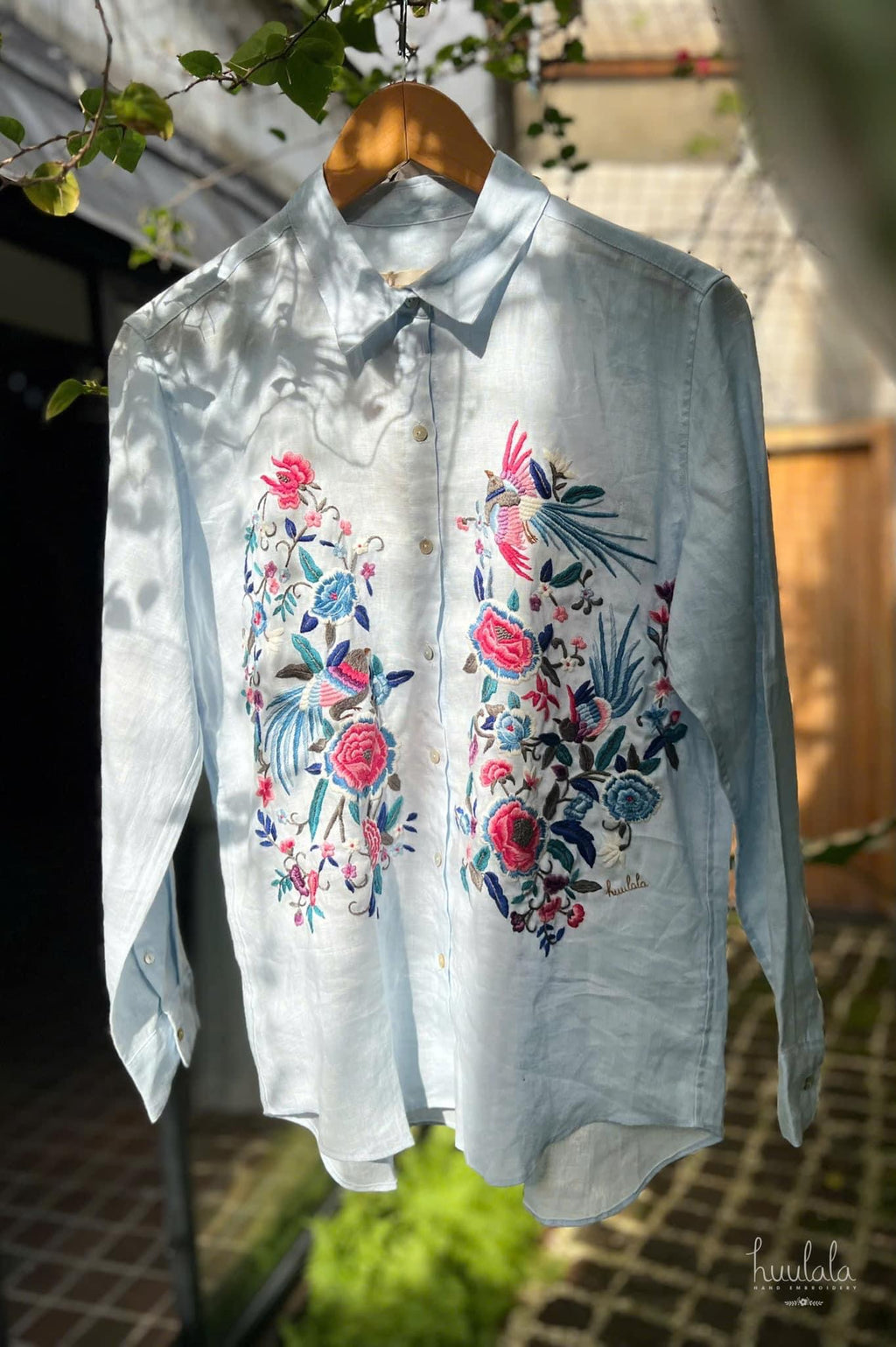 "Zoya embroidered linen shirt by Huulala, light blue with pink floral embroidery, Vietnamese design"