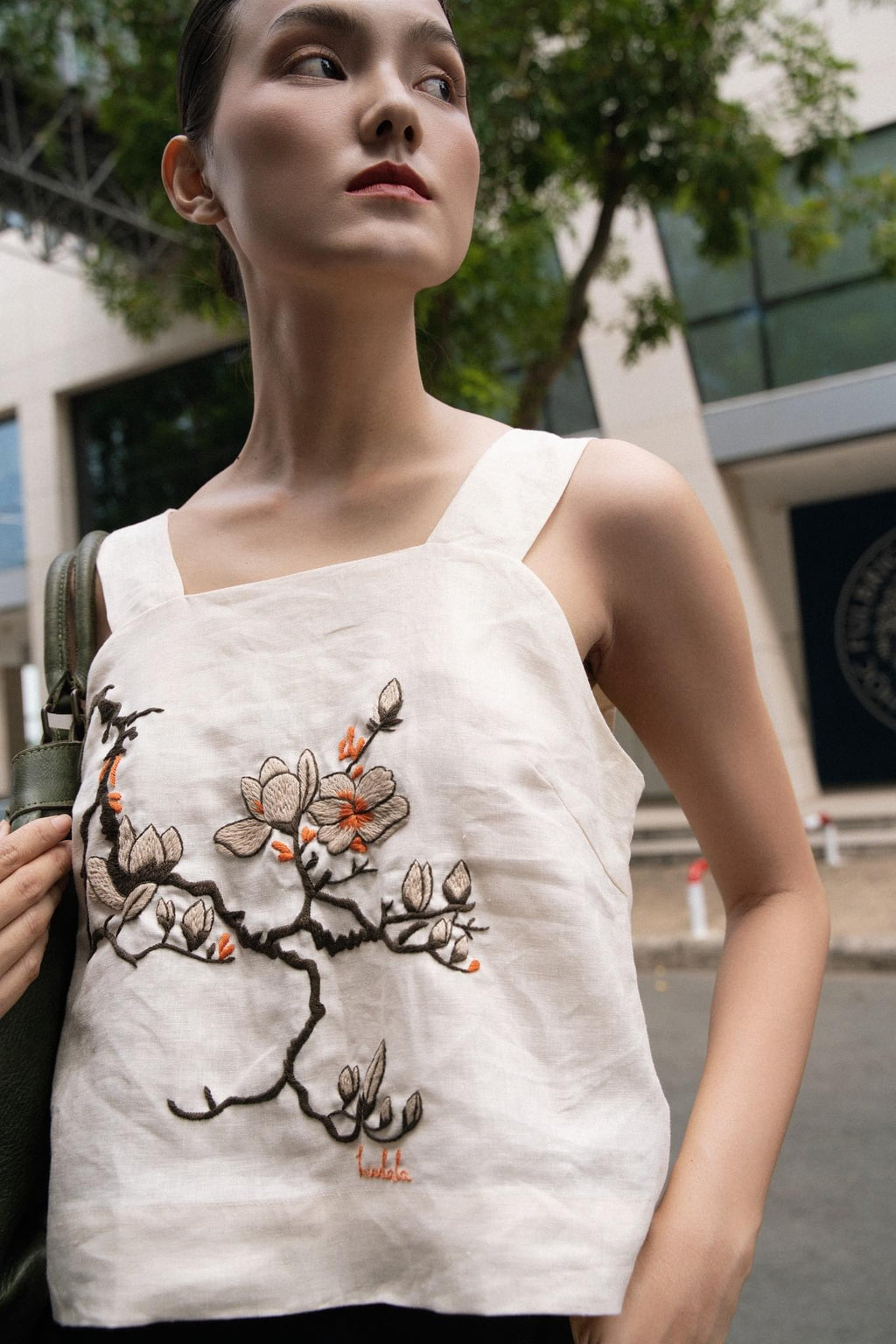 "Magnolia" white embroidered linen top by Huulala, featuring red floral modern design.