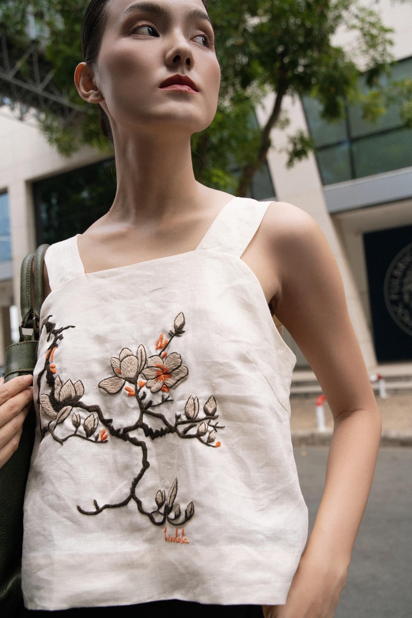 "Magnolia" white embroidered linen top by Huulala, featuring red floral modern design.