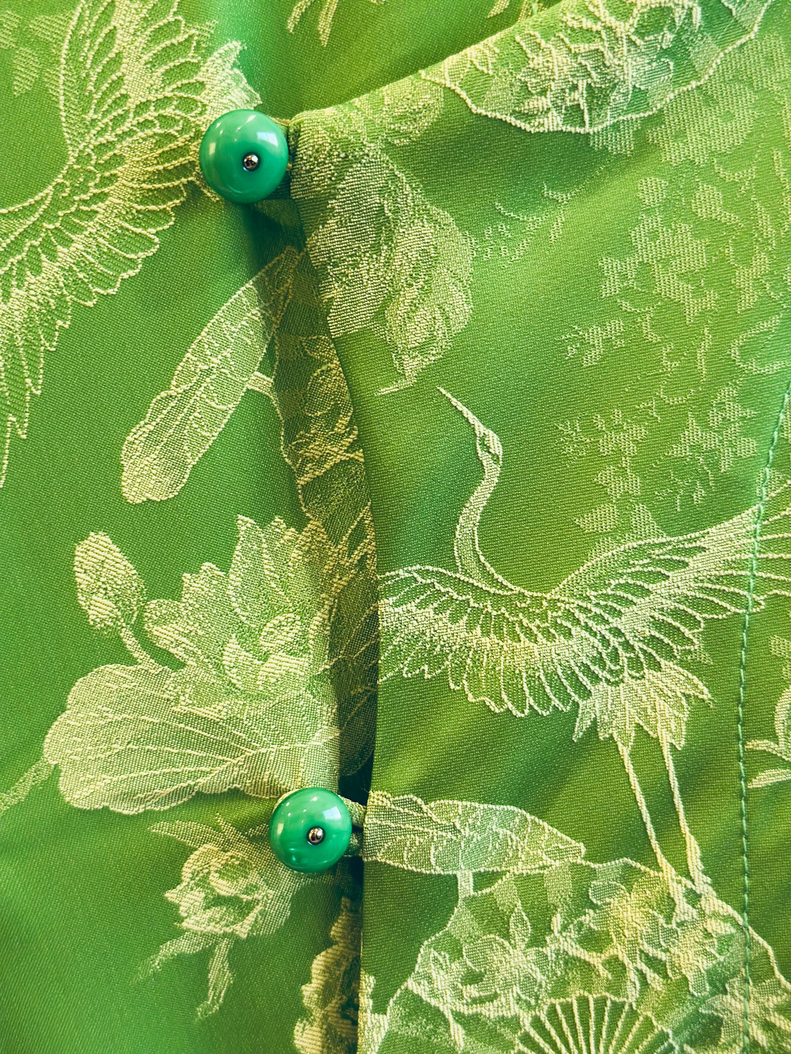 Hương Trầm - Sleeveless Cheongsam in Green with Jacquard weave - detail close-up by Hy Phuong