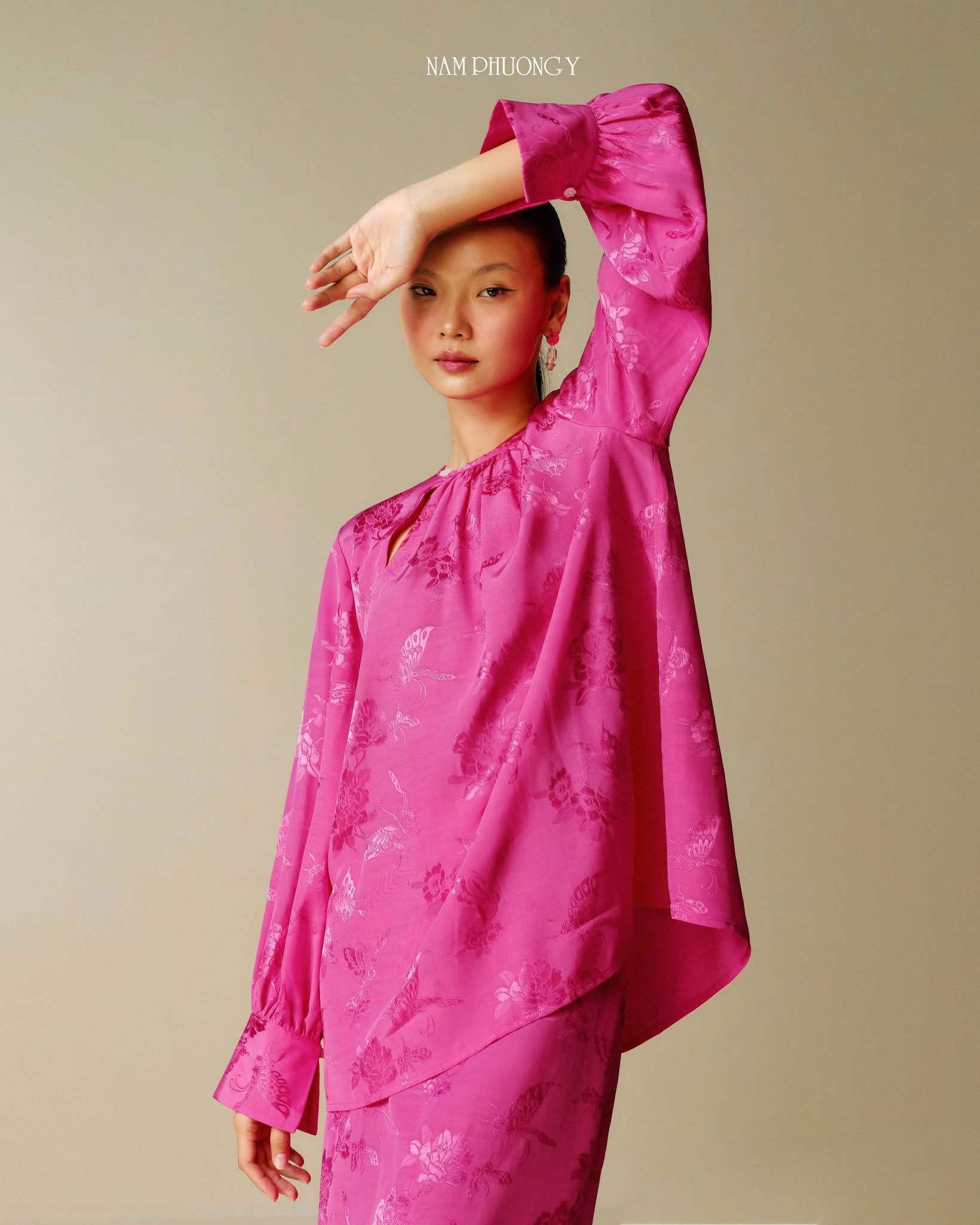 "Traditional Vietnamese dress 'Dong' in blooming fuchsia jacquard silk by Nam Phuong Y"