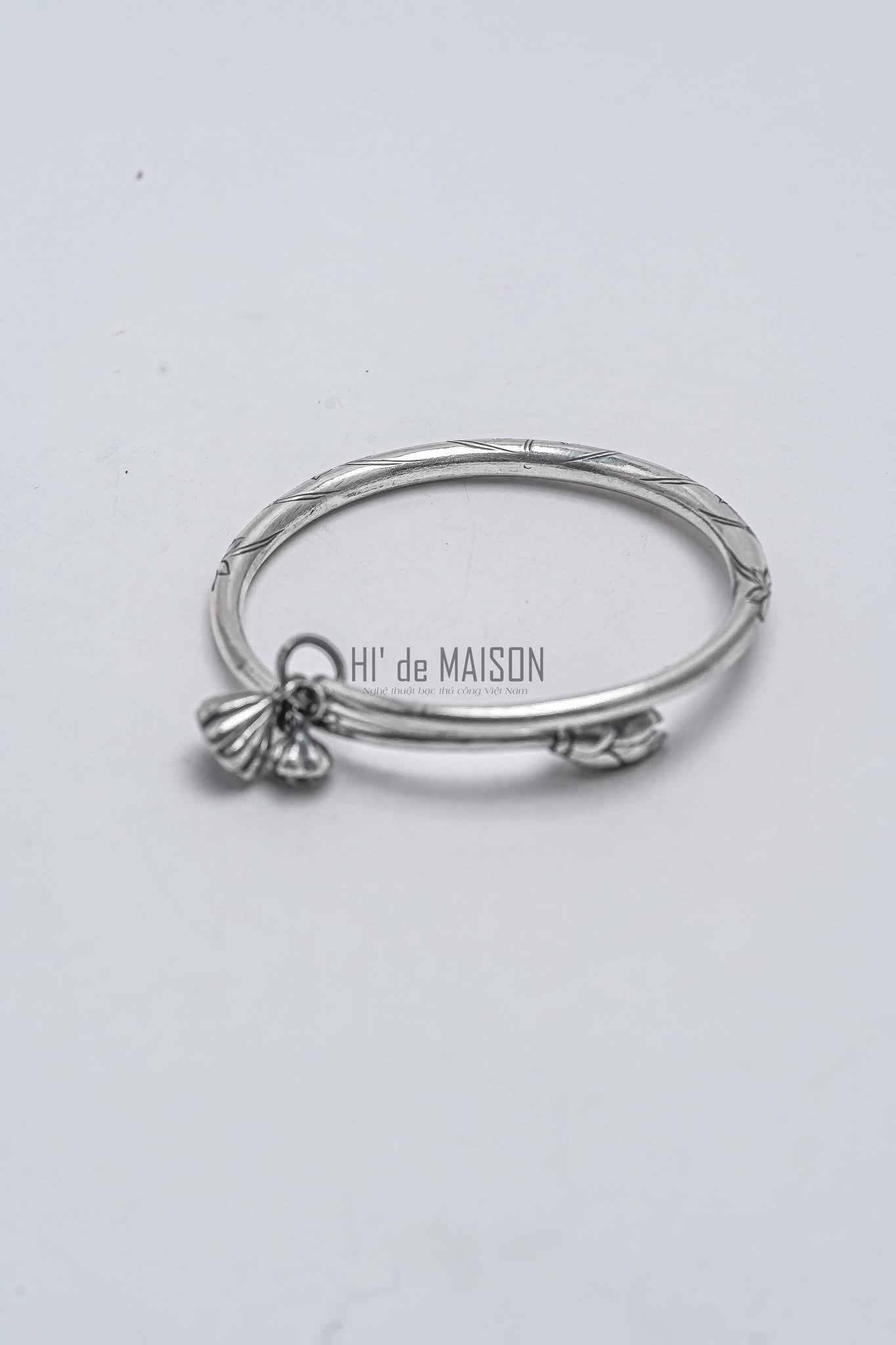 "Fine silver lotus bud bangle 'Hạ Liên' by HI de Maison, artisan-crafted with modern design."