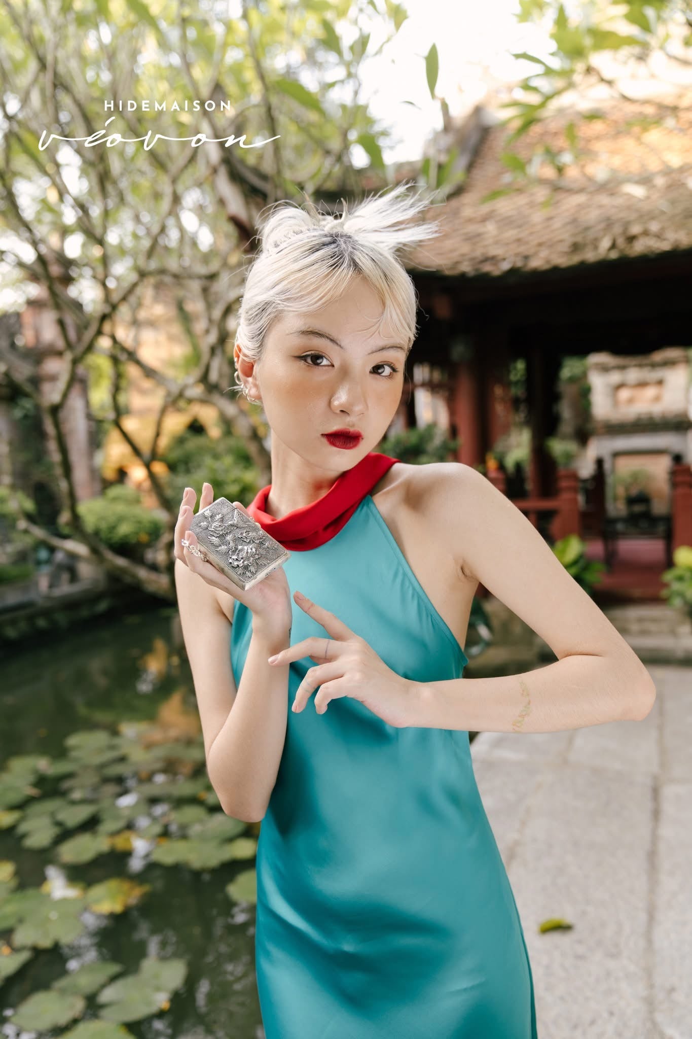 Close-up detail of Bach Hoa silver mini clutch showing intricate blooming peony embossment and antique finish