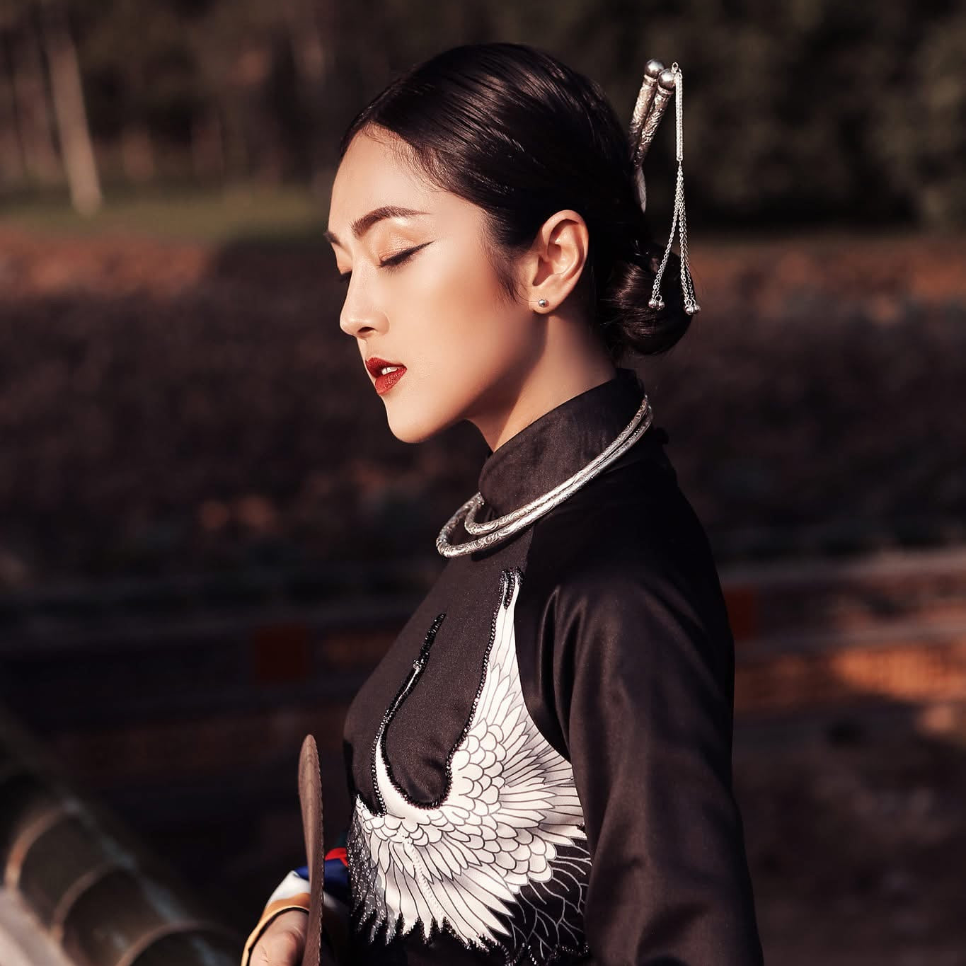 "Lien Tri Torque Necklace in Fine-silver Lotus Pattern by HI de Maison, artisan-crafted, red and silver modern design, cultural heritage."