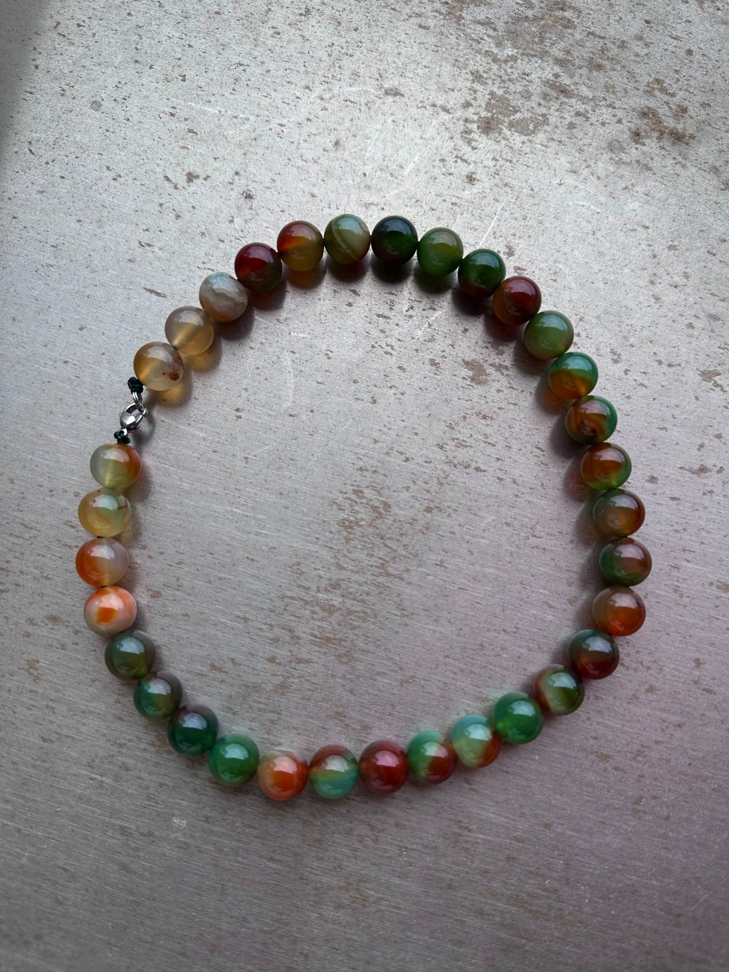 "Verdant Echo" Marble Necklace in Mossy Amber - lifestyle shot | Vietnamese Luxury Fashion