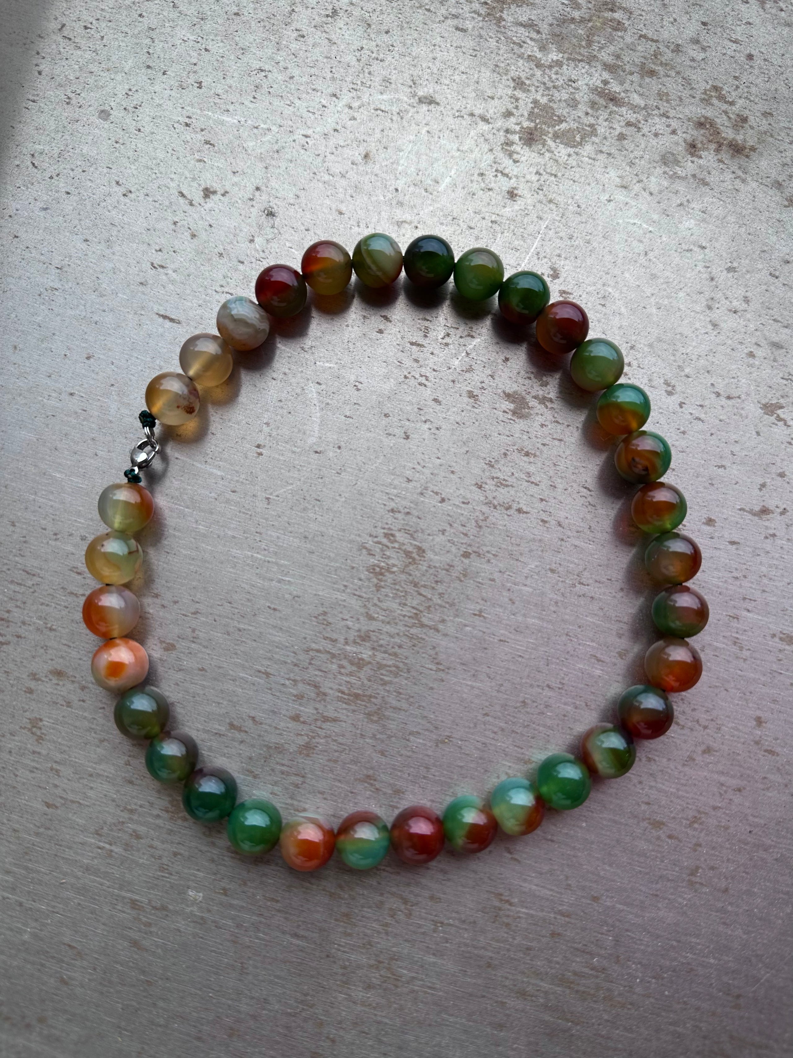 "Verdant Echo" Marble Necklace in Mossy Amber - lifestyle shot | Vietnamese Luxury Fashion