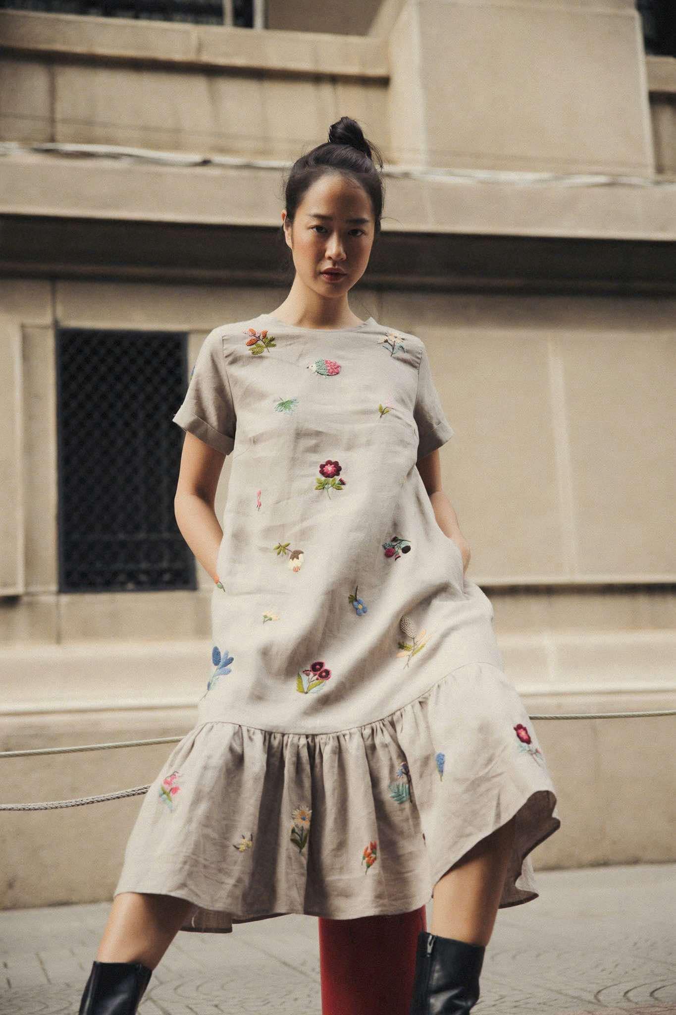 "Jacky" embroidered linen ruffled dress in gray by Huulala, featuring floral patterns.