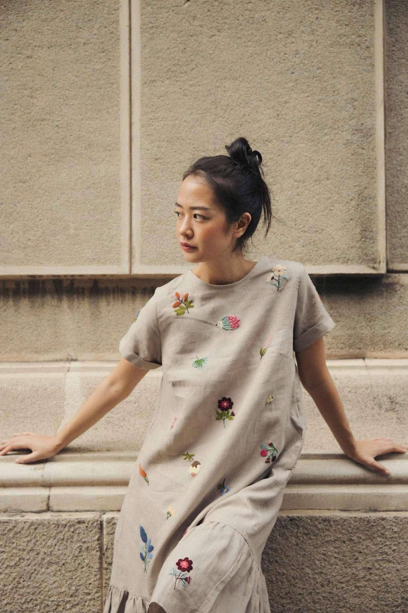 "Jacky" embroidered linen ruffled dress in gray by Huulala, featuring colorful floral patterns.