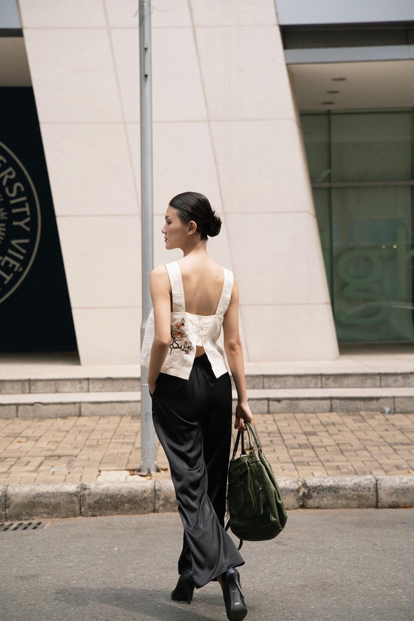 "Magnolia white embroidered linen top by Huulala, modern floral design, sleeveless, back view"