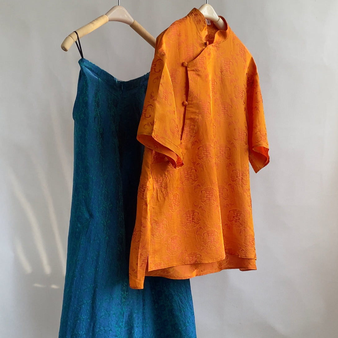 Traditional Motif - Ninh Van Set - Mandarin-neck Wormsilk in Tangerine & Bright Teal - side profile in orange by Hy Phuong