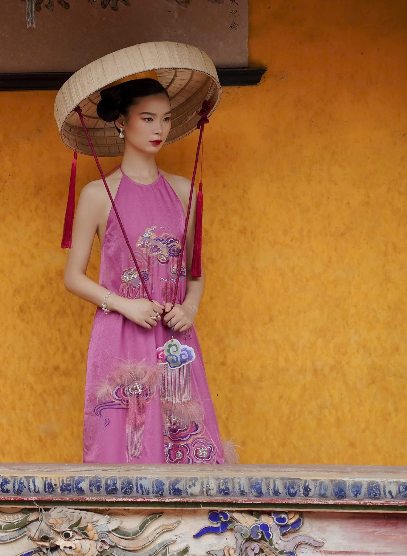 "Uyen Van luxury embellished pink velvet Ao Dai halter dress by Lalin, traditional Vietnamese attire."