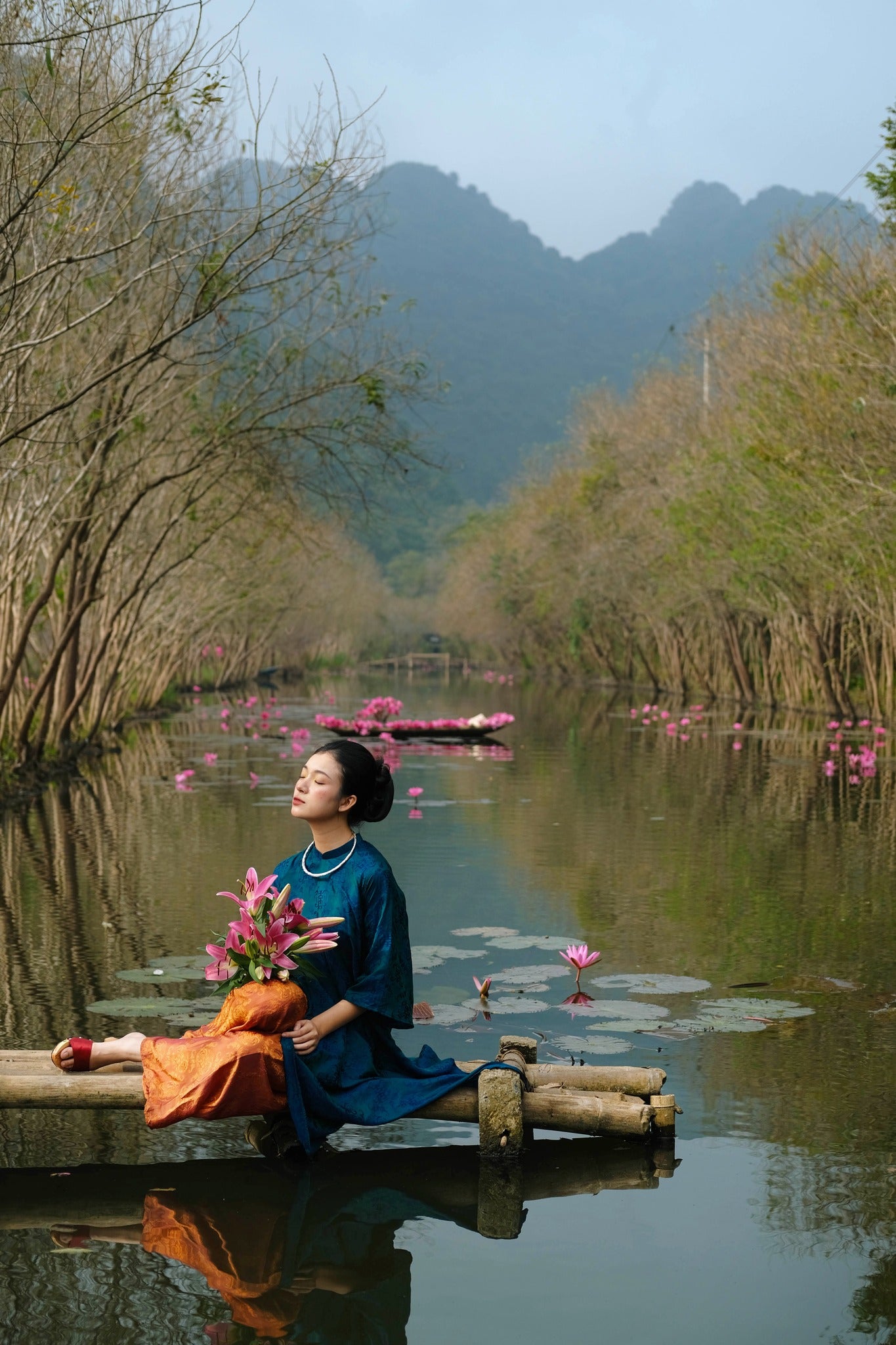 "Loc Tho Ao Dai set in red silk with modern cut, traditional Vietnamese dress by Moc, artisan-crafted."
