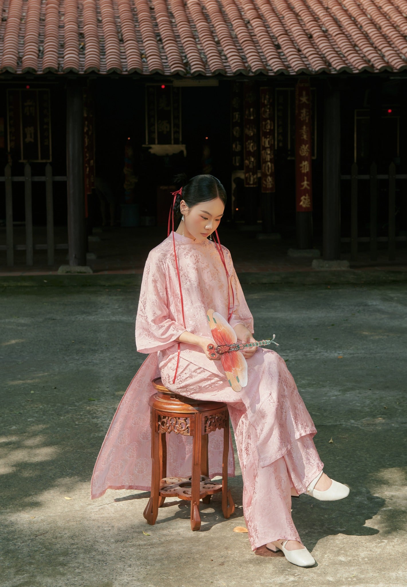 "Loc Tho Ao Dai set in light pink silk, traditional Vietnamese dress by Moc, featuring artisan jacquard pattern."