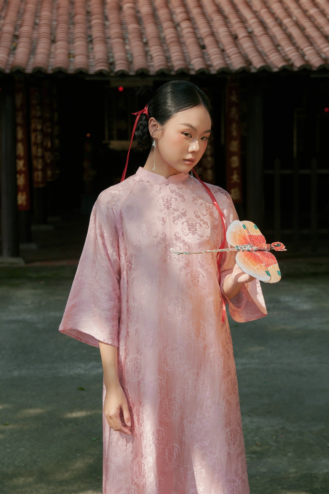 "Loc Tho Ao Dai set in light pink wormsilk, traditional Vietnamese dress by Moc, featuring artisan jacquard pattern."