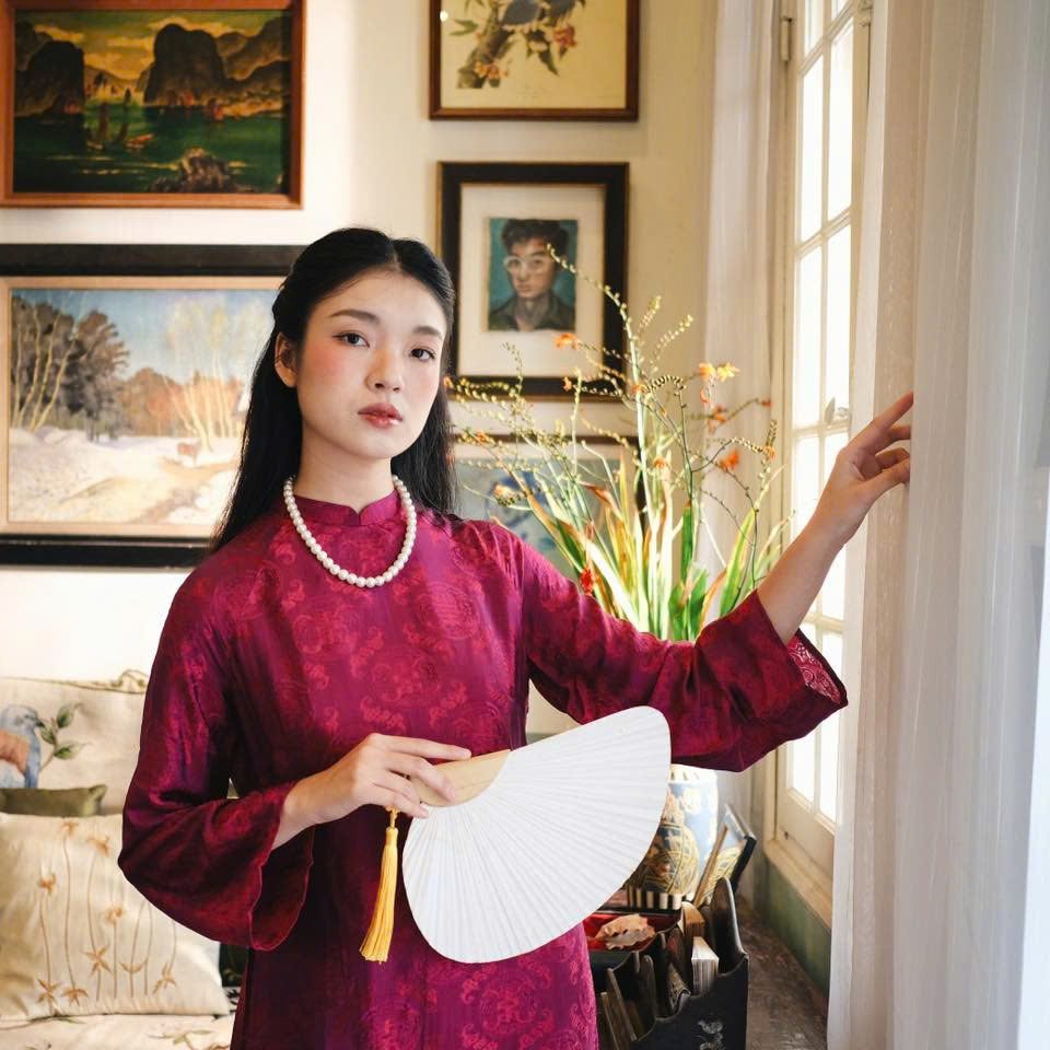 "Loc Tho Ao Dai set in dark magenta wormsilk, traditional Vietnamese dress, artisan jacquard pattern."
