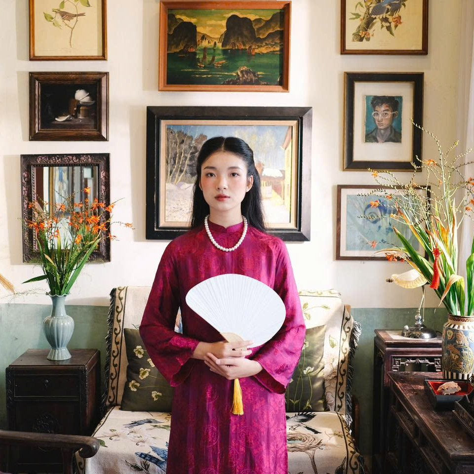 "Loc Tho Ao Dai set in dark magenta wormsilk, traditional Vietnamese dress with artisan jacquard pattern."