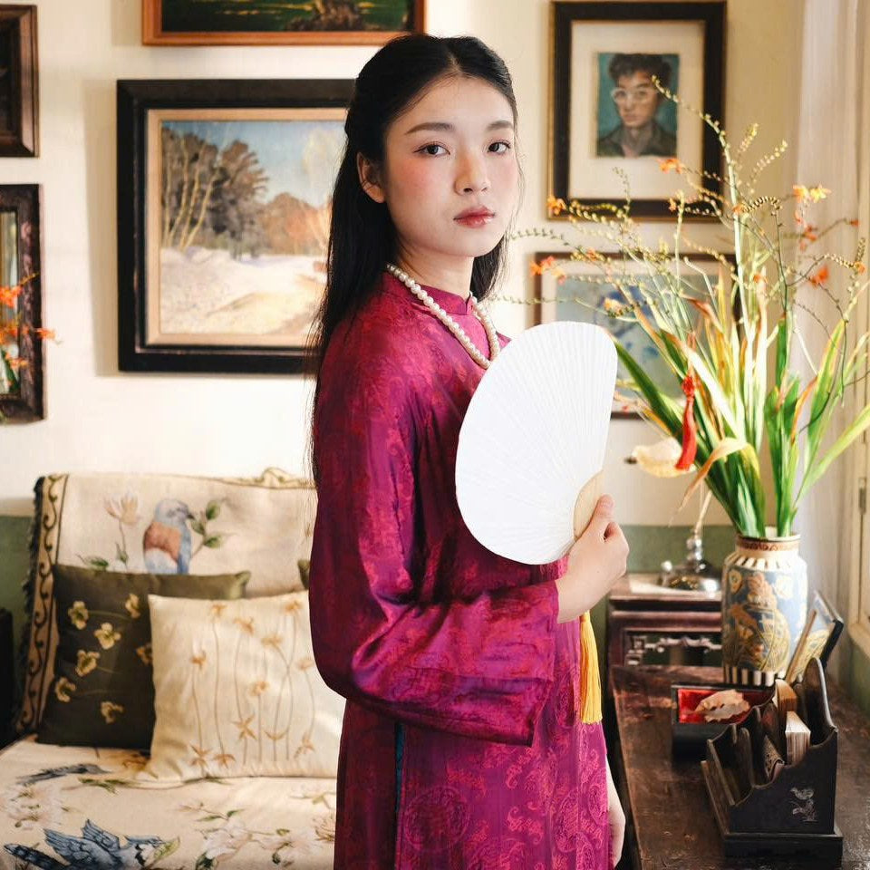"Loc Tho Ao Dai set in dark magenta wormsilk, traditional Vietnamese dress with artisan jacquard pattern."