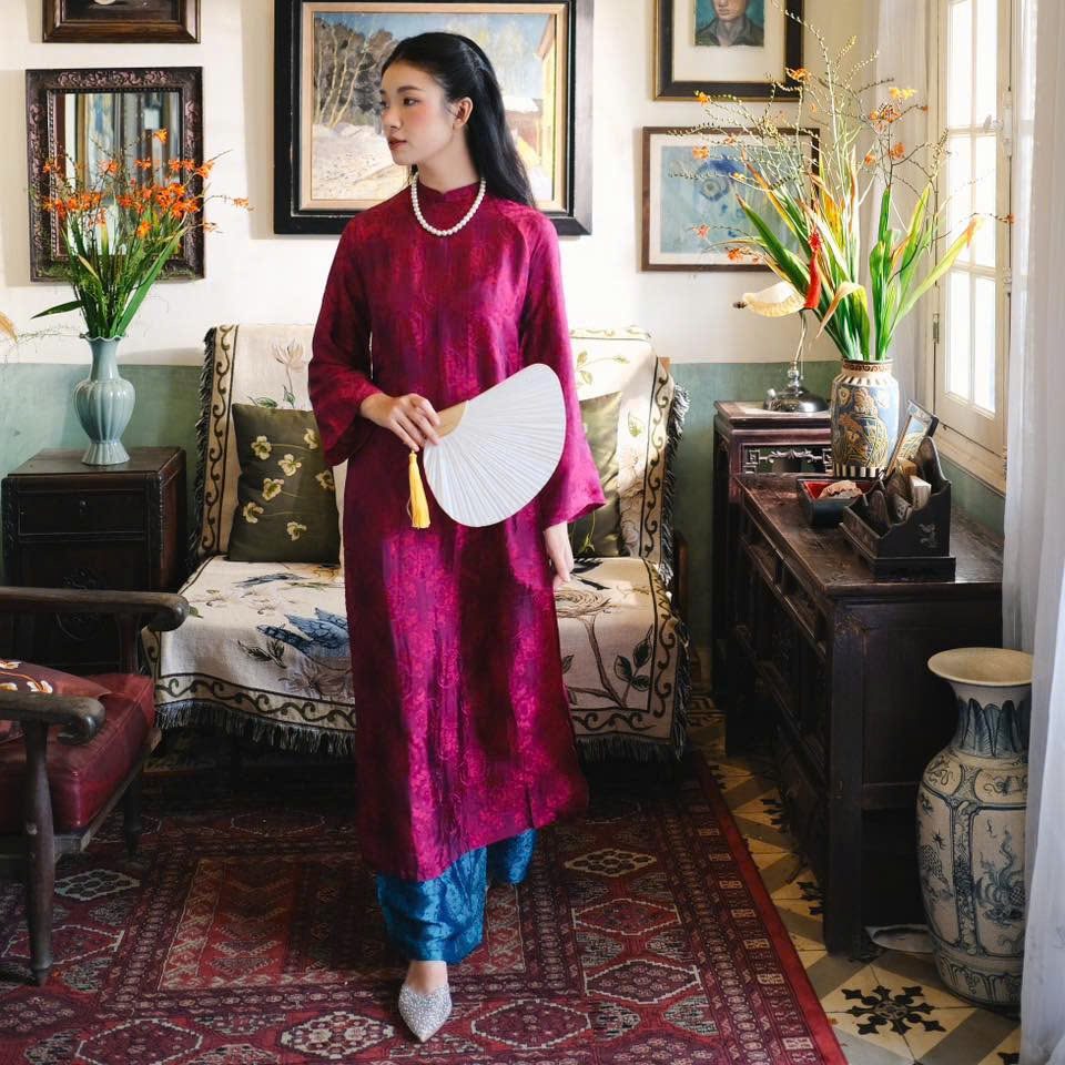 "Loc Tho Ao Dai set in dark magenta wormsilk, traditional Vietnamese dress with modern jacquard pattern."
