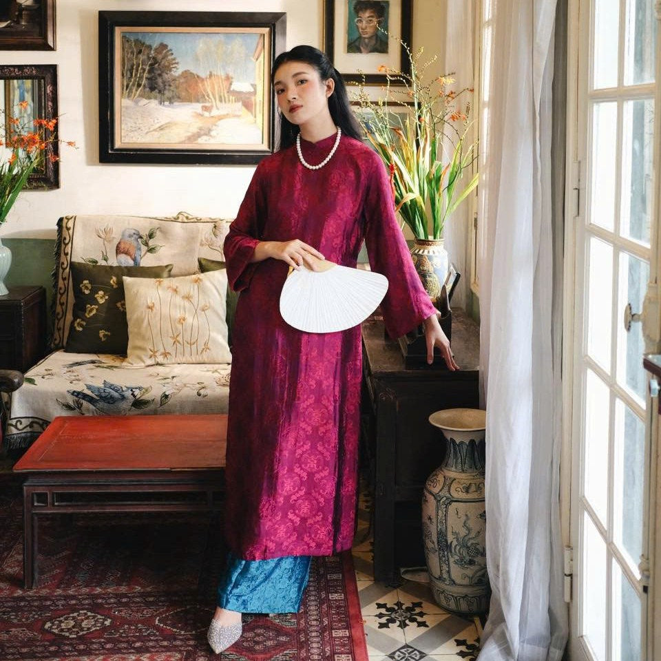 "Loc Tho Ao Dai set in dark magenta wormsilk, traditional Vietnamese dress with artisan jacquard pattern."