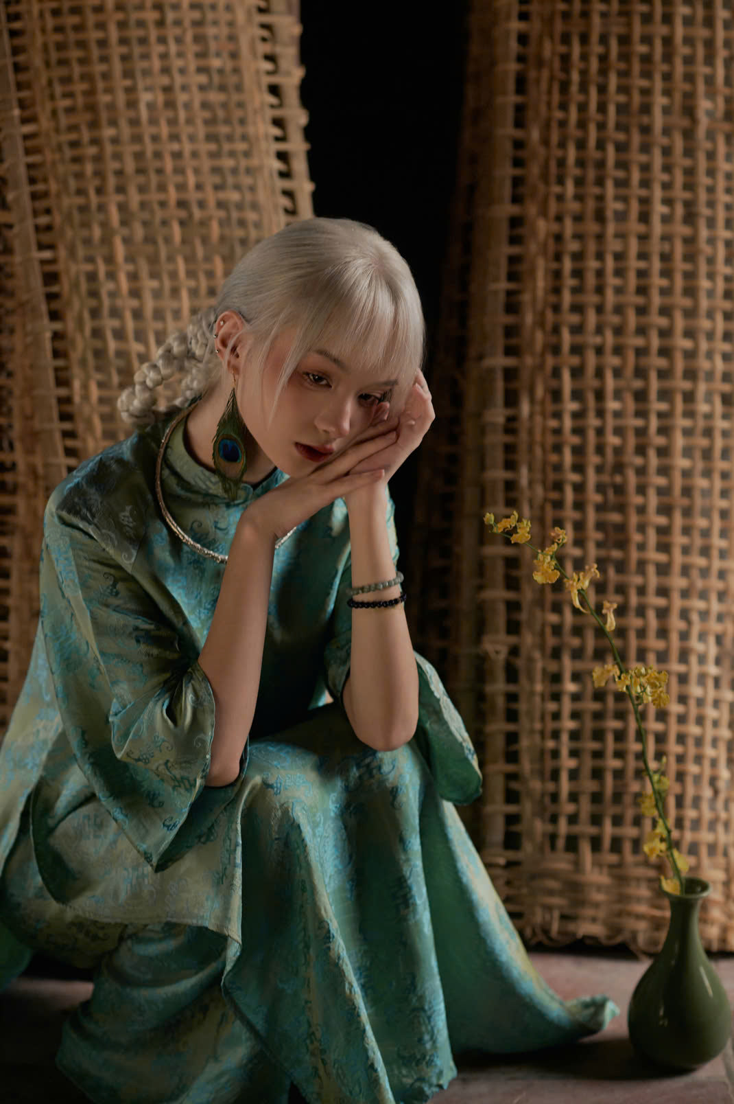 "Loc Tho Ao Dai set in jade silk, traditional Vietnamese dress by Moc, artisan jacquard pattern."