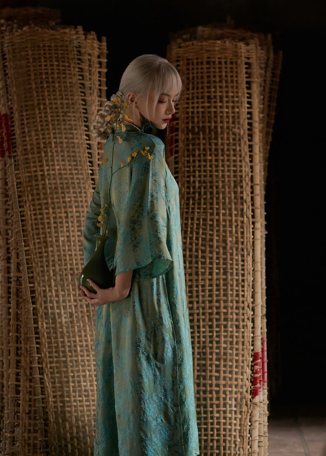 "Loc Tho Ao Dai set in jade silk, traditional Vietnamese dress with artisan jacquard pattern."
