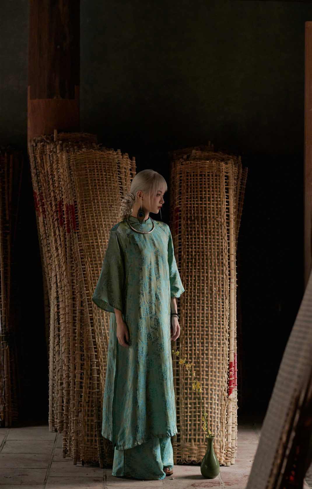 "Loc Tho Ao Dai set in jade silk, traditional Vietnamese dress with artisan jacquard pattern."