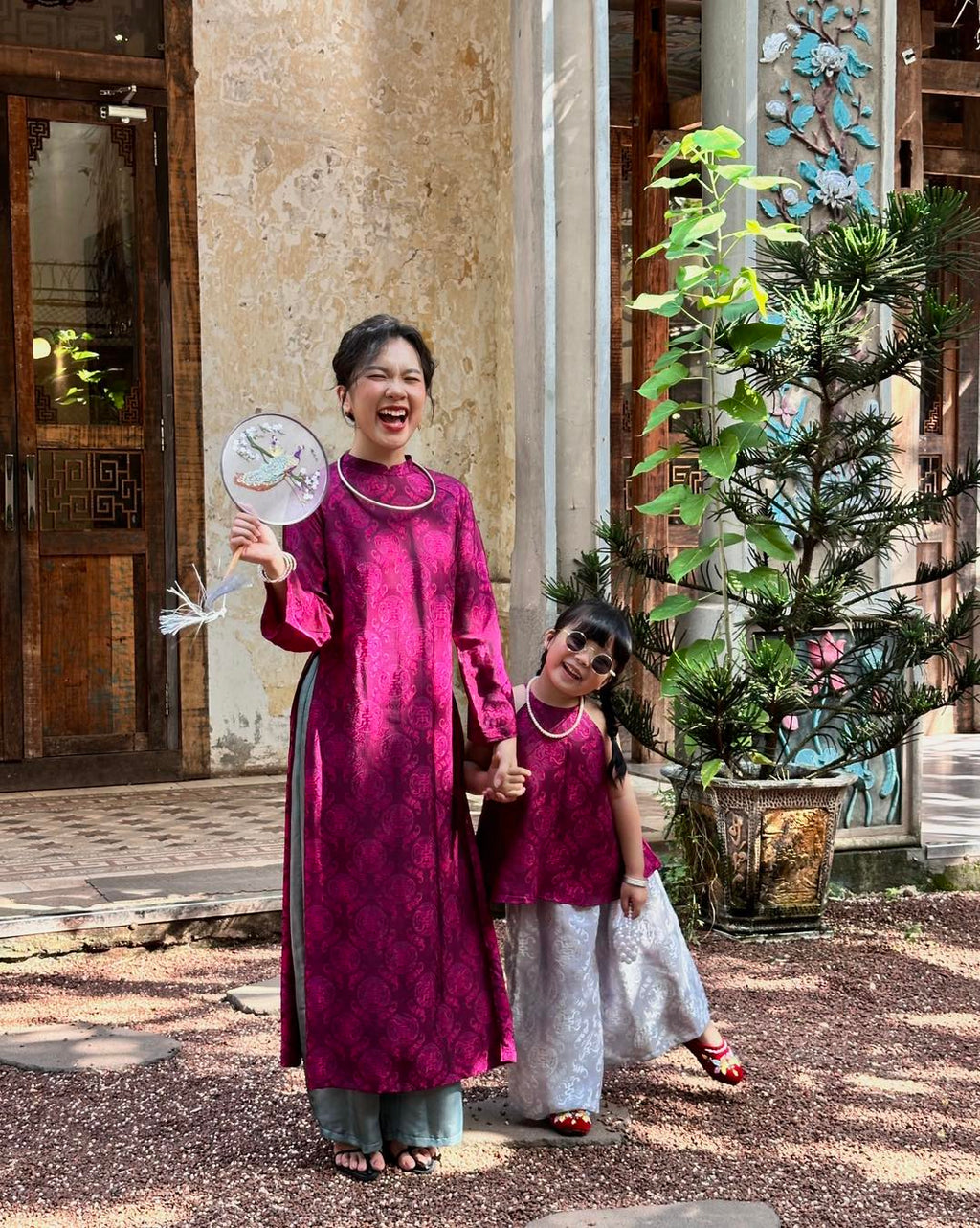 "Loc Tho Ao Dai set in dark magenta wormsilk, traditional Vietnamese dress with artisan jacquard pattern."