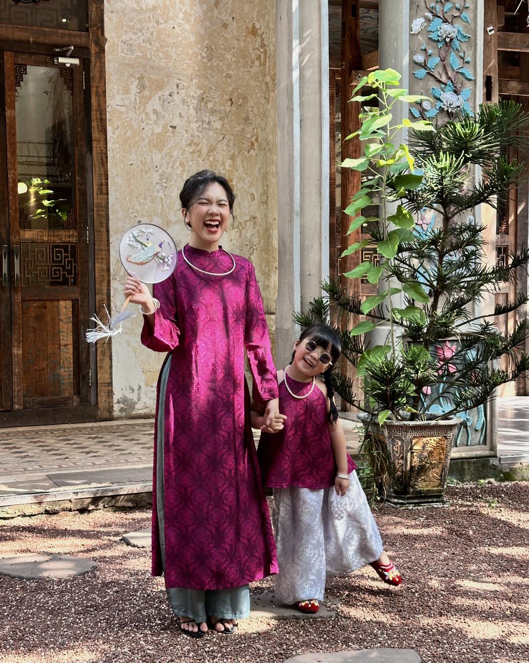 "Loc Tho Ao Dai set in dark magenta wormsilk, traditional Vietnamese dress with artisan jacquard pattern."