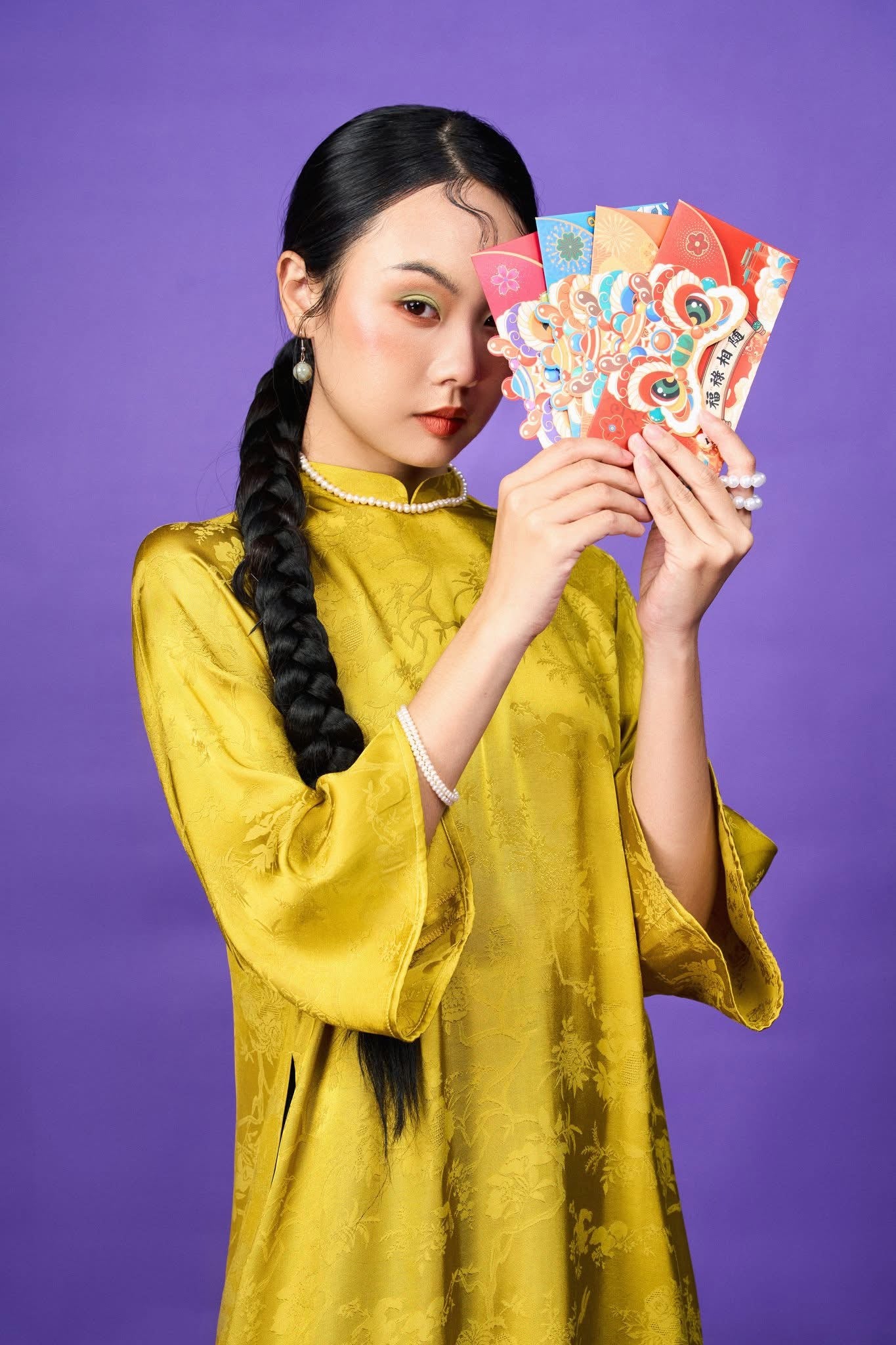 "Yellow jacquard silk Ao dai set by Moc, showcasing traditional Vietnamese elegance with peacock wormsilk pants."