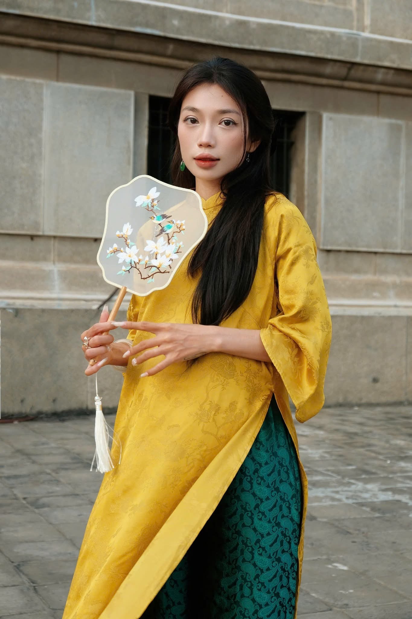 "Moc Cam Vang Ao Dai set in yellow jacquard silk with peacock wormsilk pants, traditional Vietnamese dress."