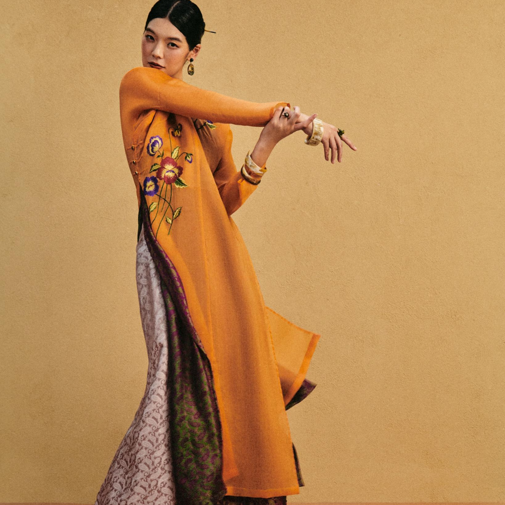 Lifestyle shot of Marigold Reverie" Luxury Ao-dai Set - Dual-layered Hand-Embroidered Organic Organza and Silk Ensemble from lo Boutique - Front view
