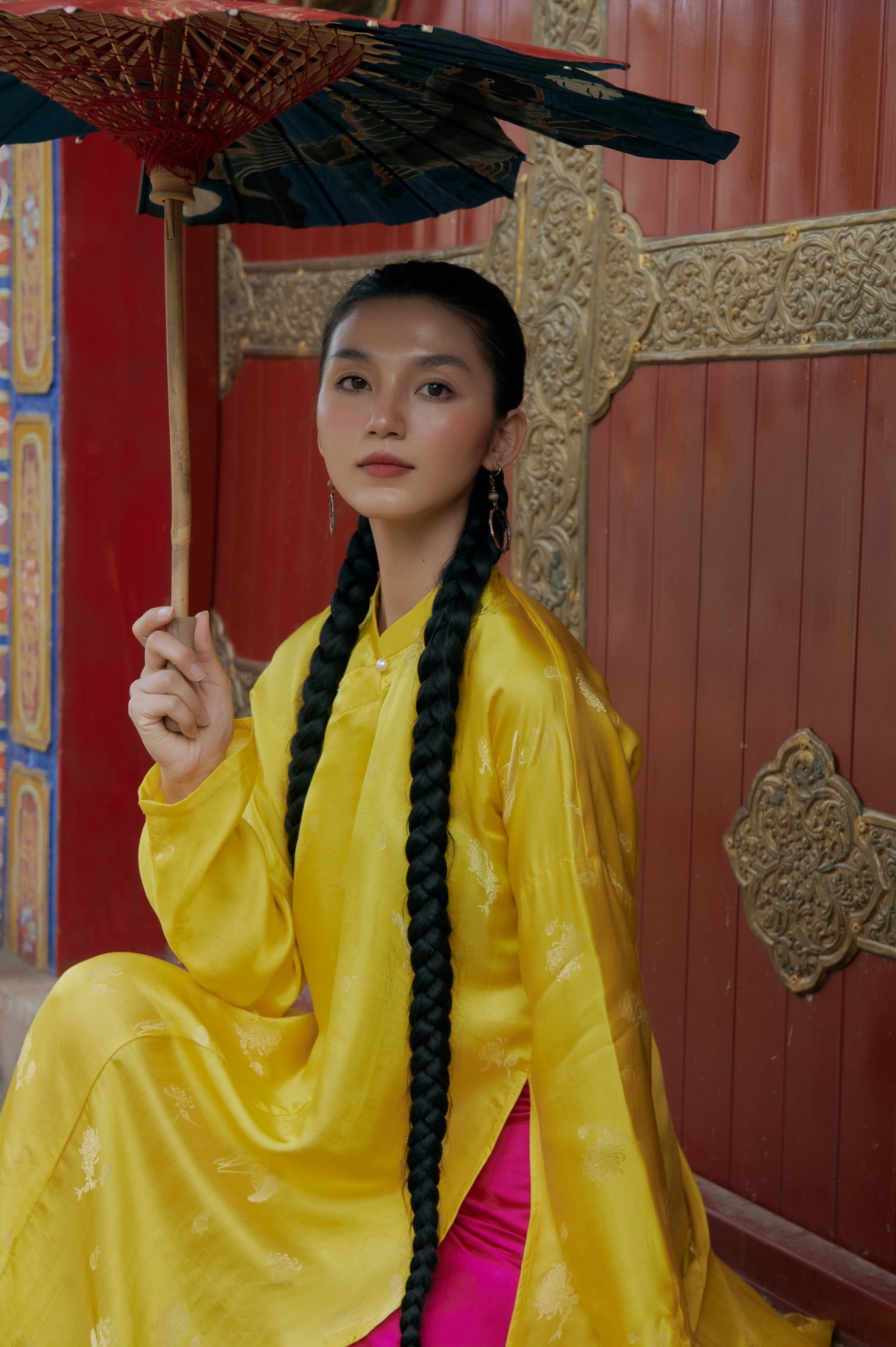"Traditional Vietnamese Ao Dai in yellow silkworm silk by Moc, featuring artisan woven patterns."