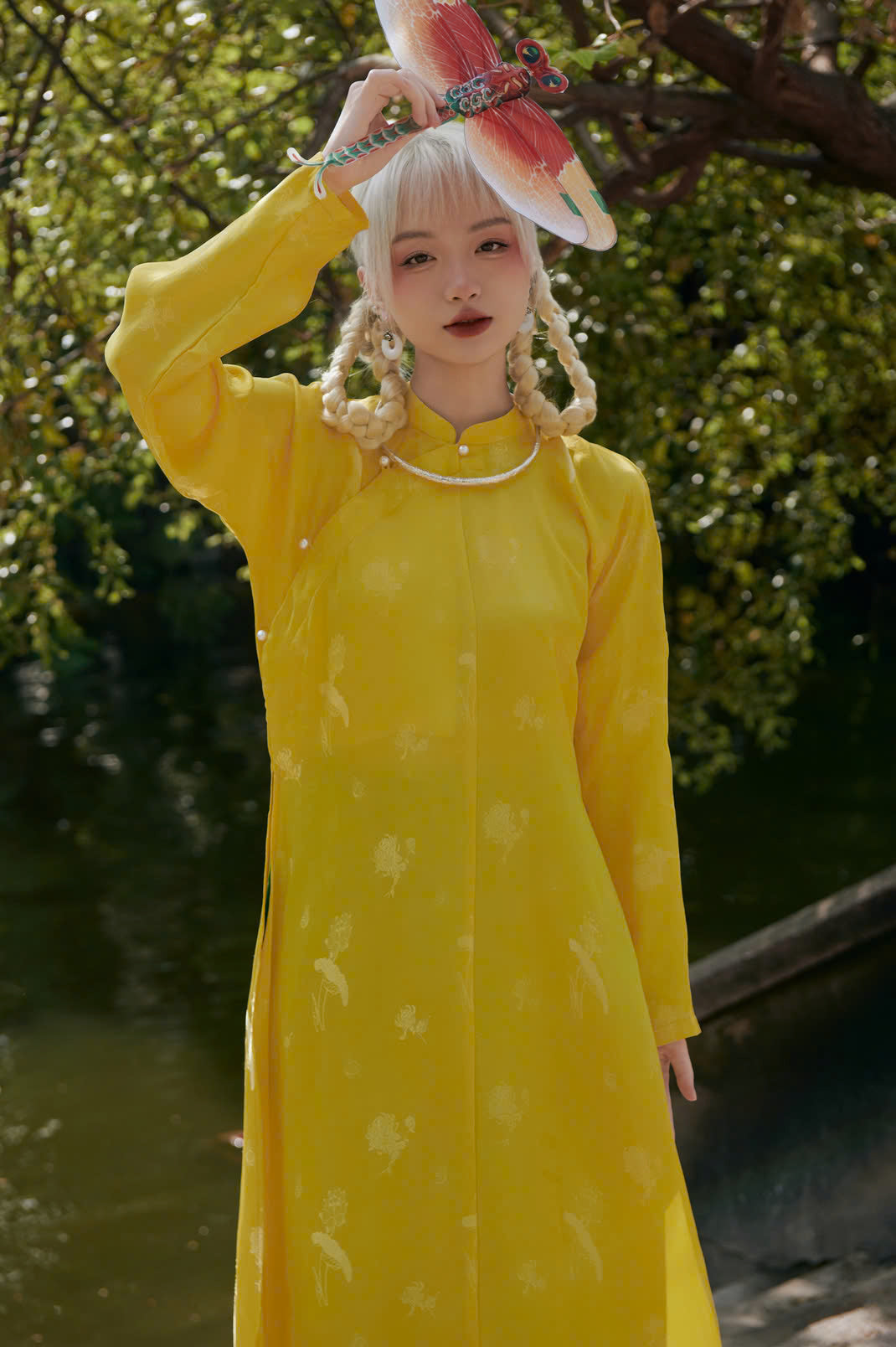 "Traditional Vietnamese Ao Dai in yellow silkworm silk with modern woven patterns by Moc."