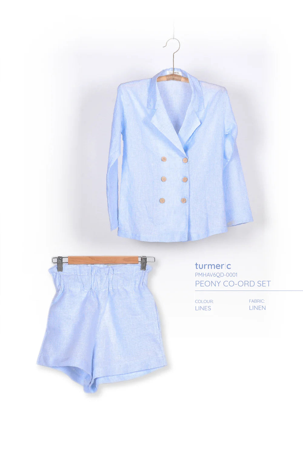 "Peony - Linen Set in Blue by Turmeric, featuring a double-breasted blazer and shorts in light blue linen."