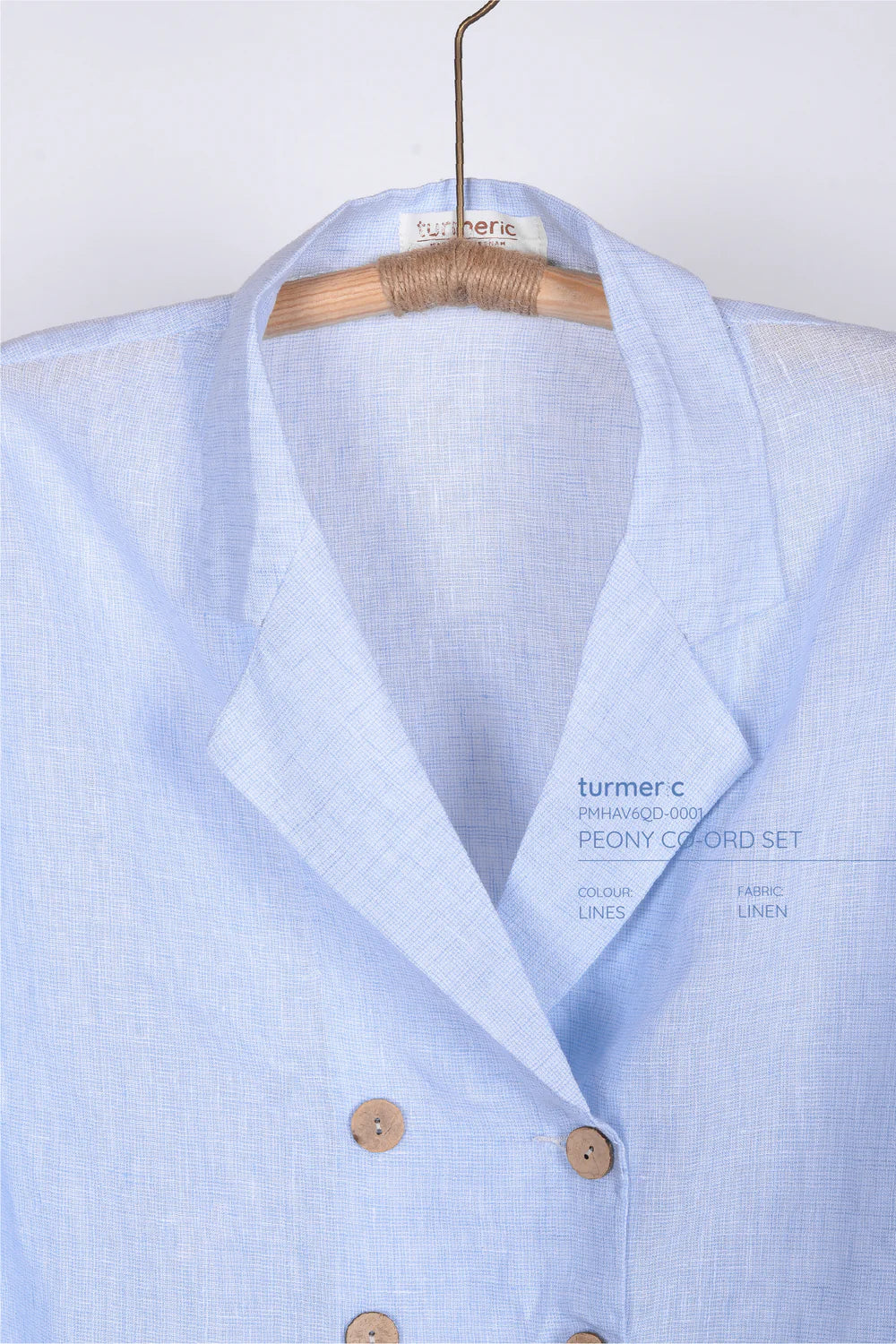 "Peony - Linen Set in Blue by Turmeric, light blue linen fabric, minimalist design, wooden buttons"