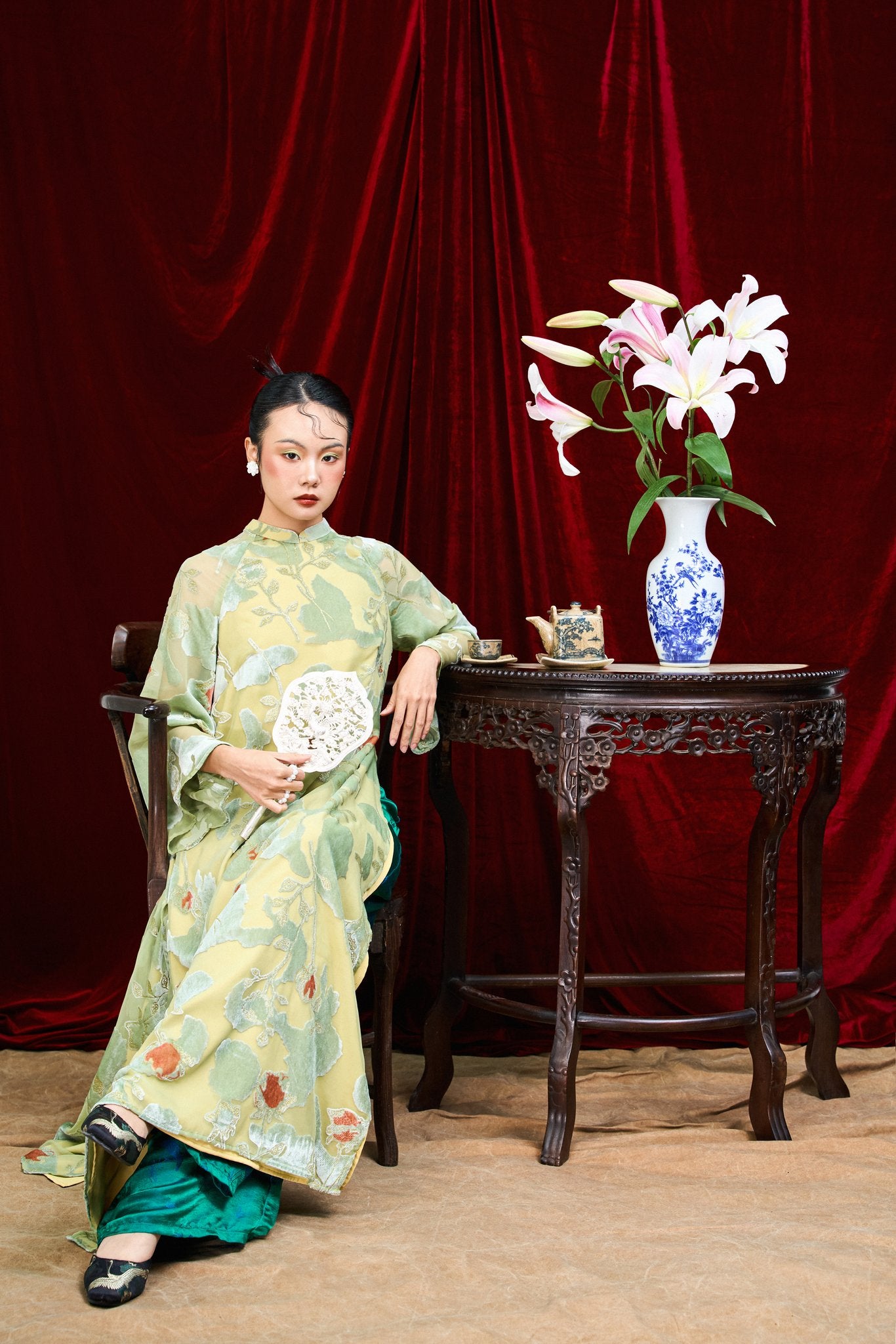 "Traditional Vietnamese Ao dai in blush coral chiffon with floral embroidery, cultural dress by Moc."