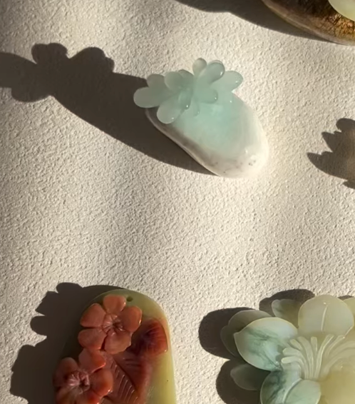 “Oliva Lotus” – Jade Necklace with Hand-Carved Lotus Pendant - flat lay display in light blue by L'Orient Haus