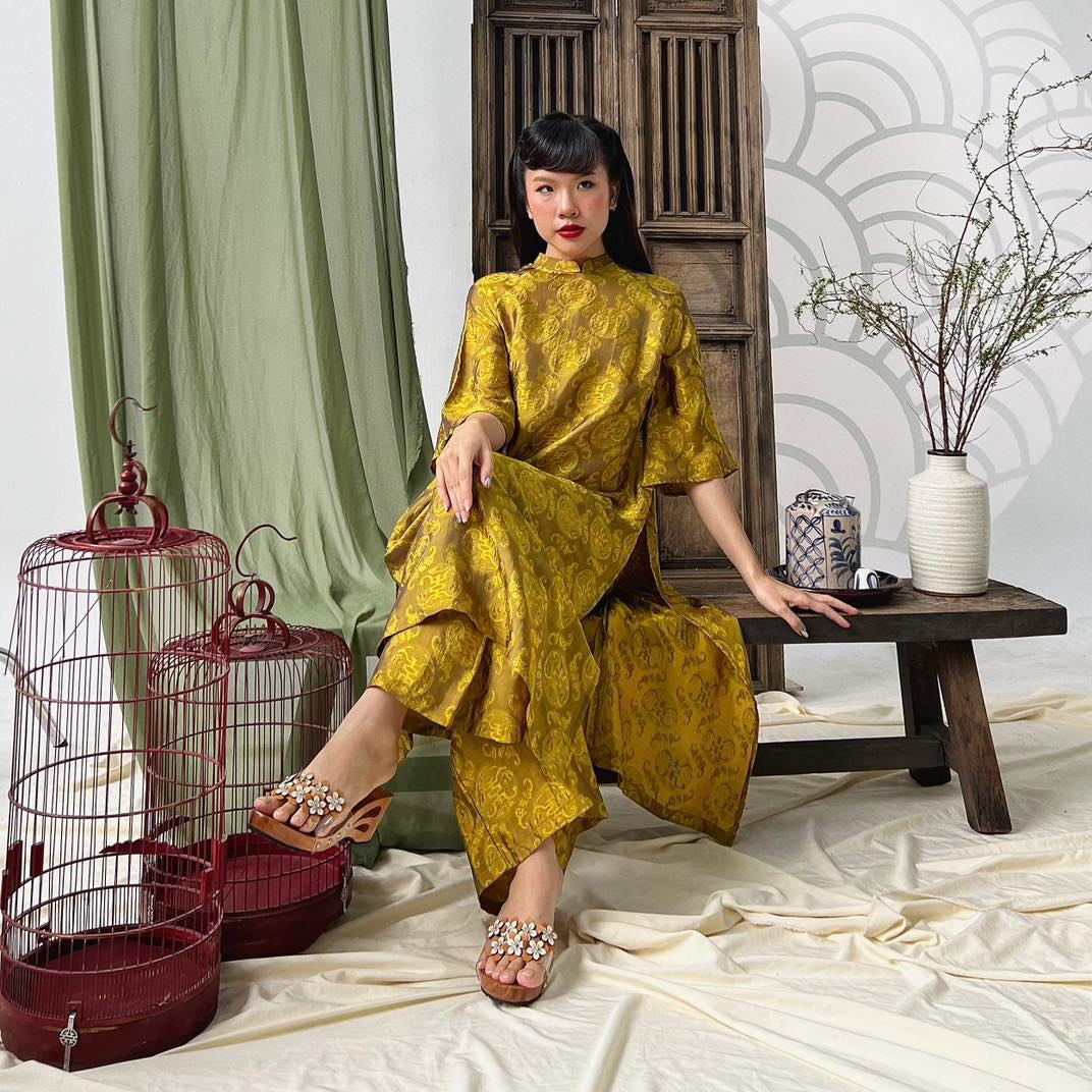 "Loc Tho Ao Dai set in light moss wormsilk, traditional Vietnamese dress with jacquard pattern."