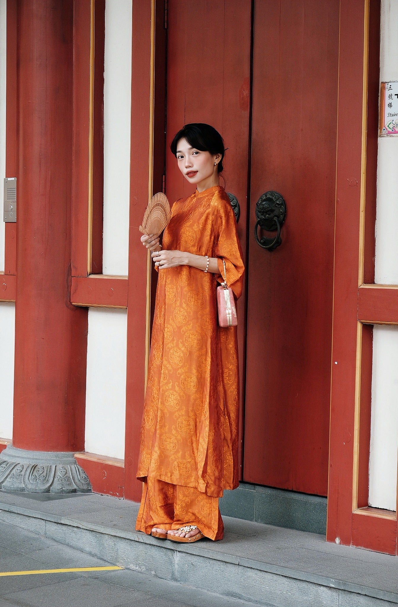 "Tho Doi Ao Dai set in orange wormsilk, traditional Vietnamese dress by Moc, artisan jacquard design"
