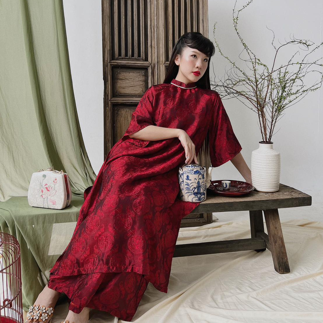 "Loc Tho Ao Dai set in crimson wormsilk, traditional Vietnamese dress by Moc, featuring artisan jacquard design."