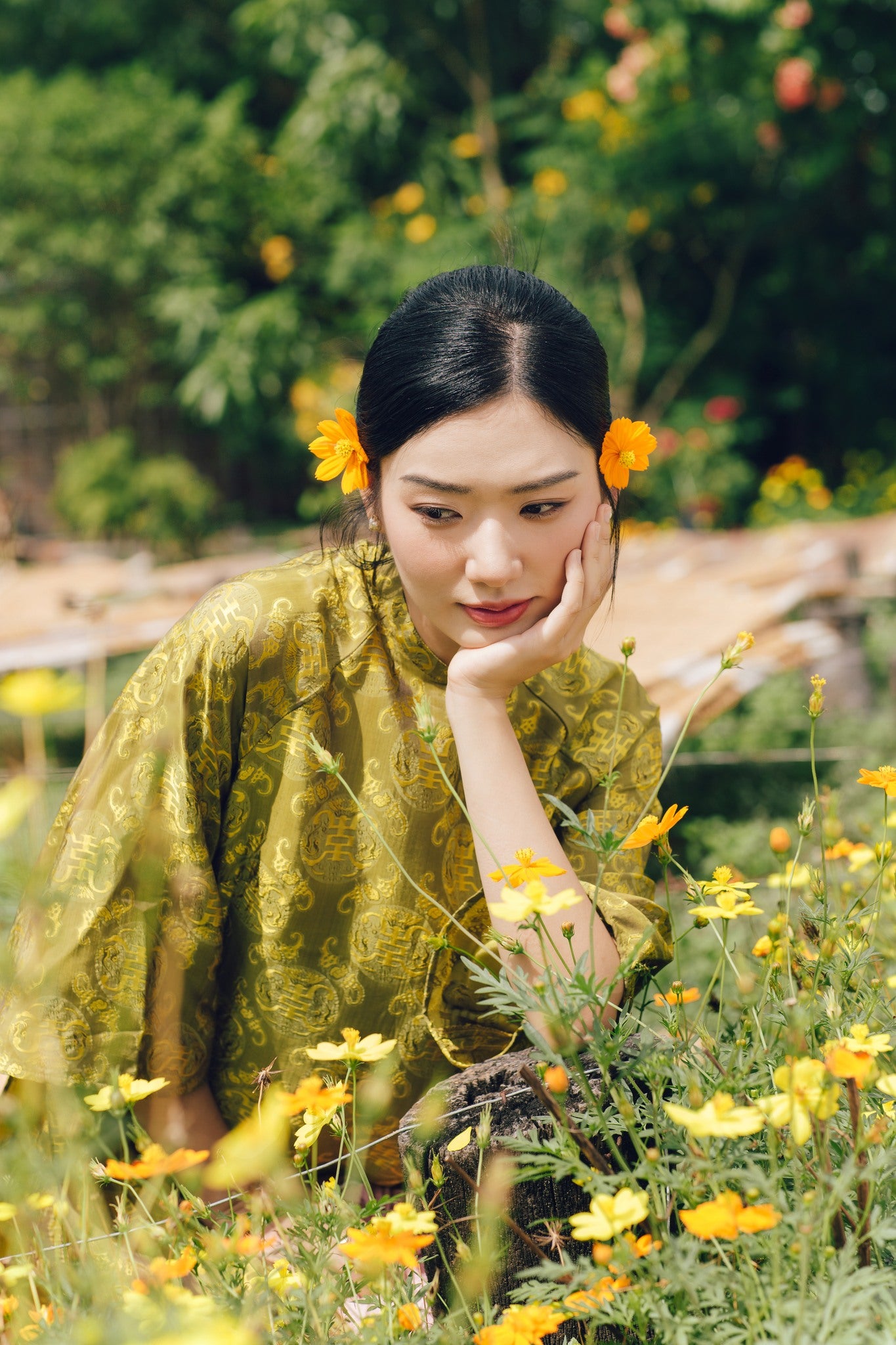 "Loc Tho Ao Dai set in light moss wormsilk, traditional Vietnamese dress with artisan jacquard pattern."