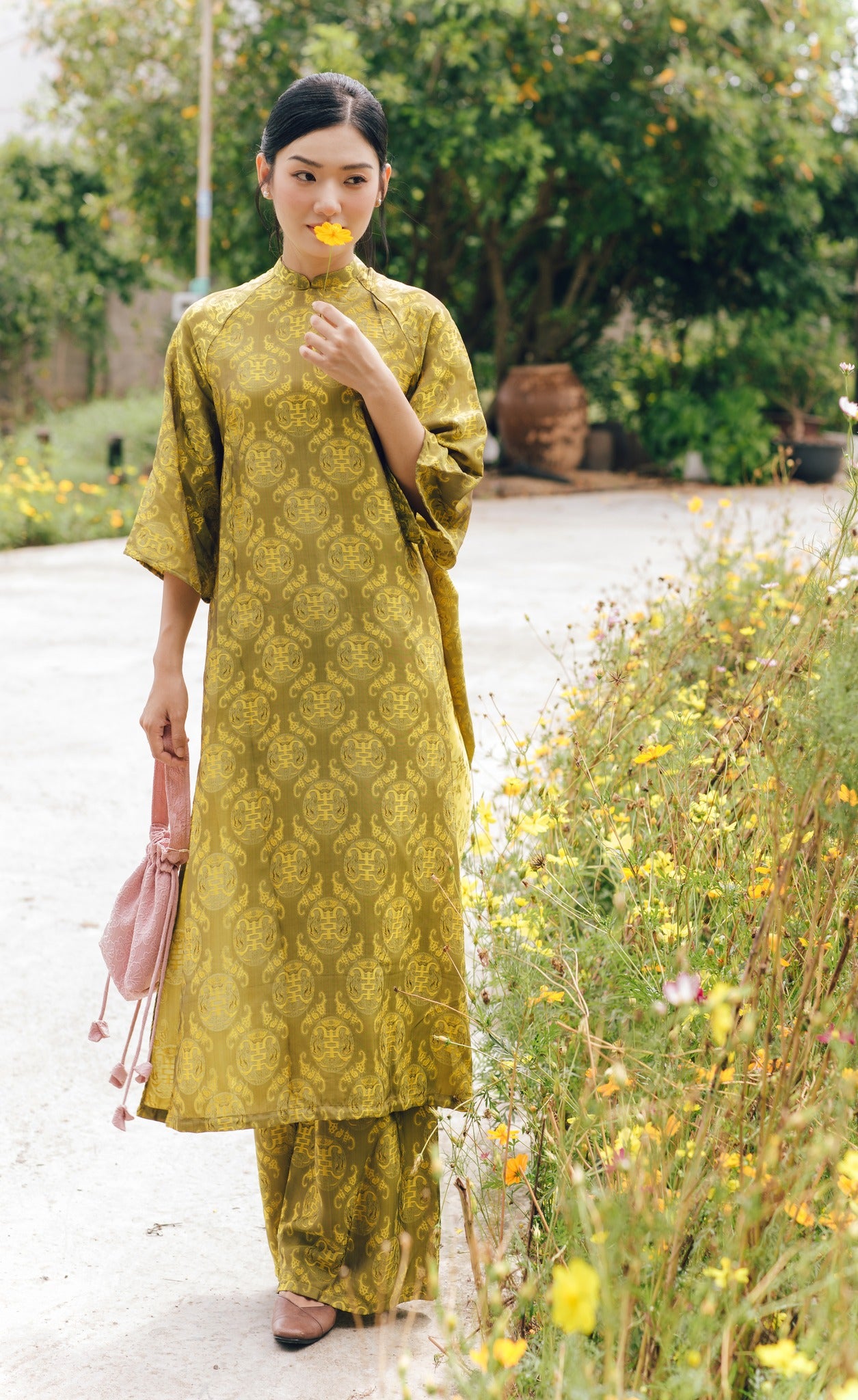 "Loc Tho Ao Dai set in light moss wormsilk, traditional Vietnamese dress with jacquard pattern."