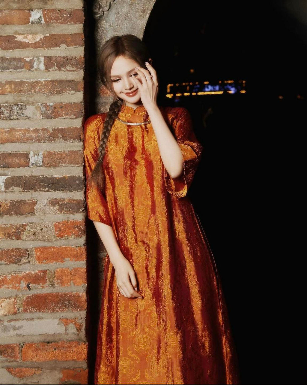 "Tho Doi Ao Dai set in orange wormsilk, traditional Vietnamese dress by Moc, artisan jacquard design."